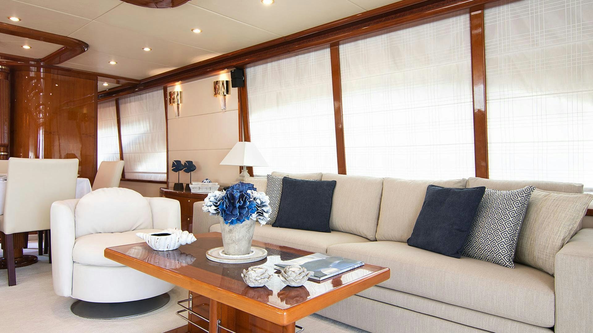 a living room with a couch and a coffee table aboard DREAM B Yacht for Charter