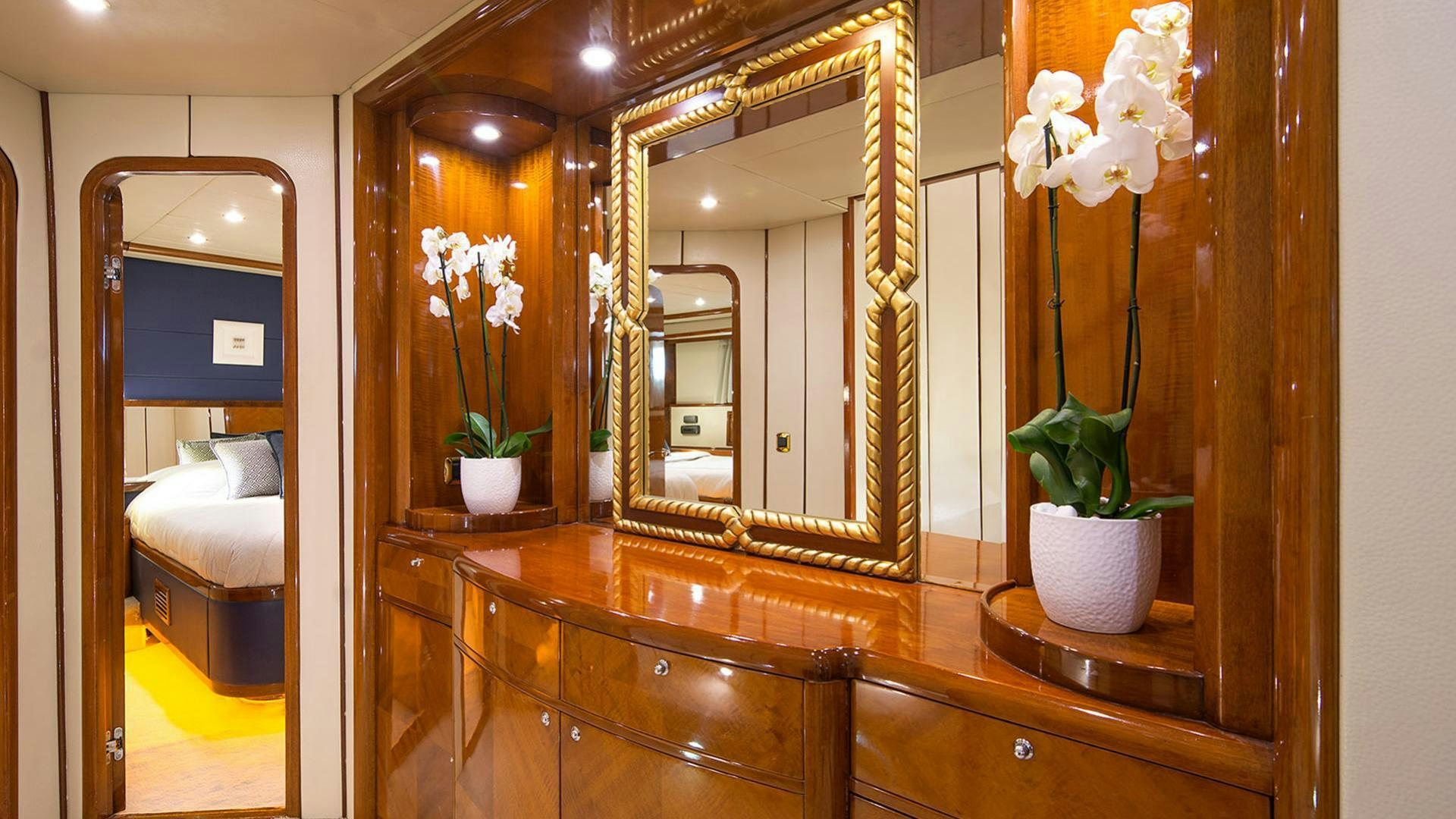 a bathroom with a mirror and flowers aboard DREAM B Yacht for Charter