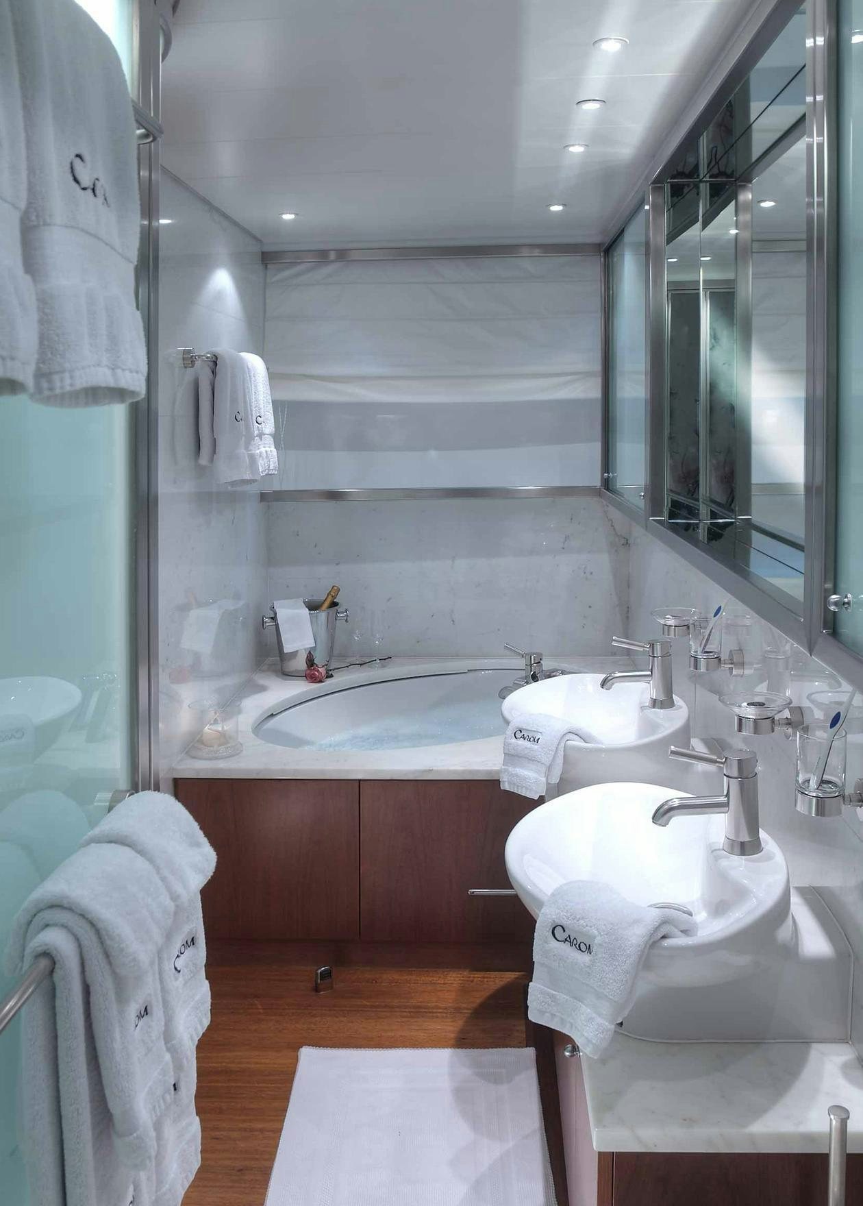a bathroom with a sink and a mirror aboard CAROM Yacht for Charter