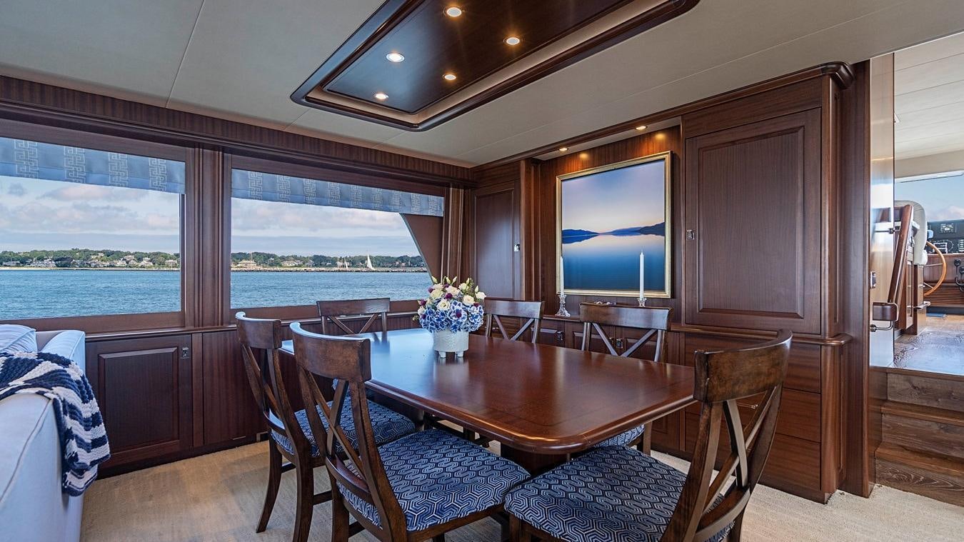 a dining table in a living room aboard TRANQUILITY Yacht for Charter