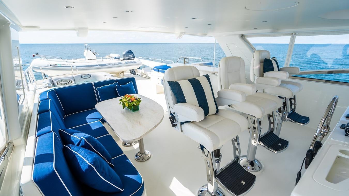a room with a table chairs and a large body of water aboard TRANQUILITY Yacht for Charter