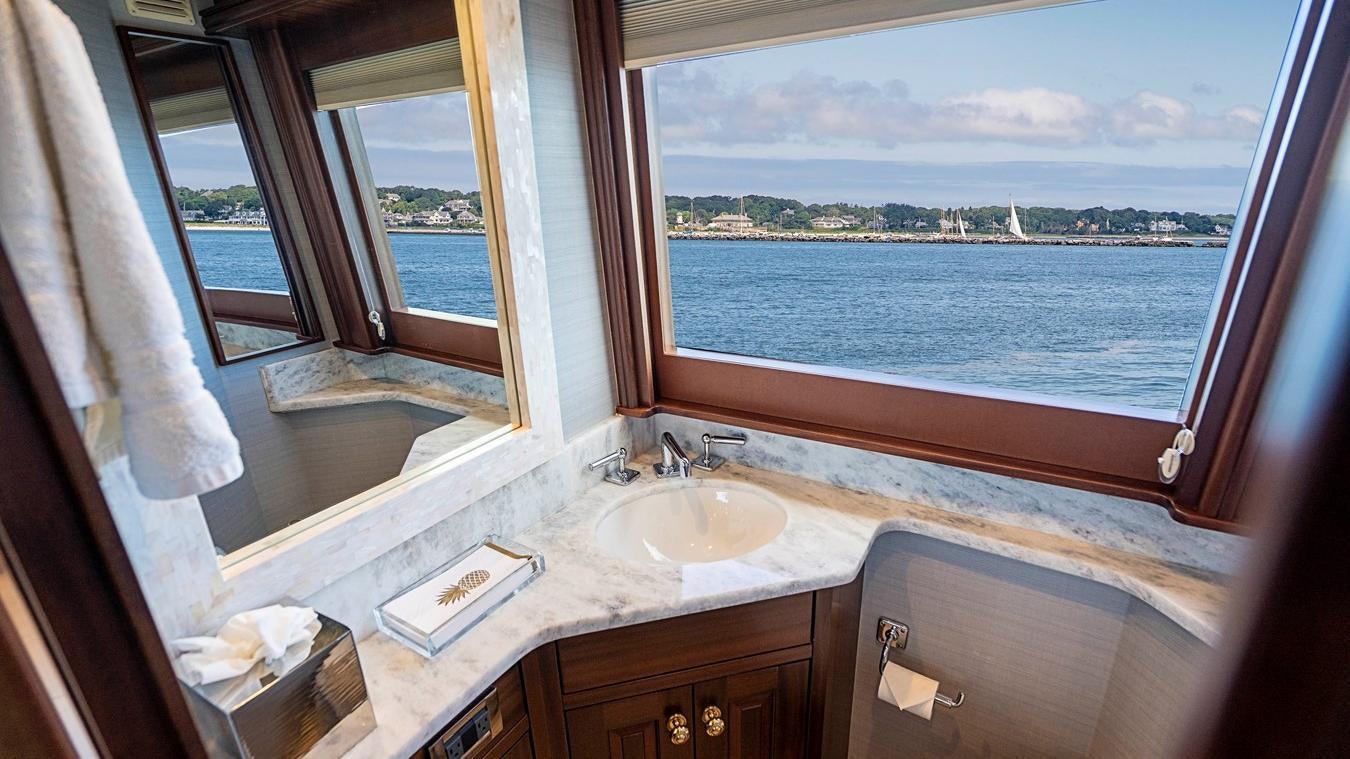 a bathroom with a sink and a large window aboard TRANQUILITY Yacht for Charter