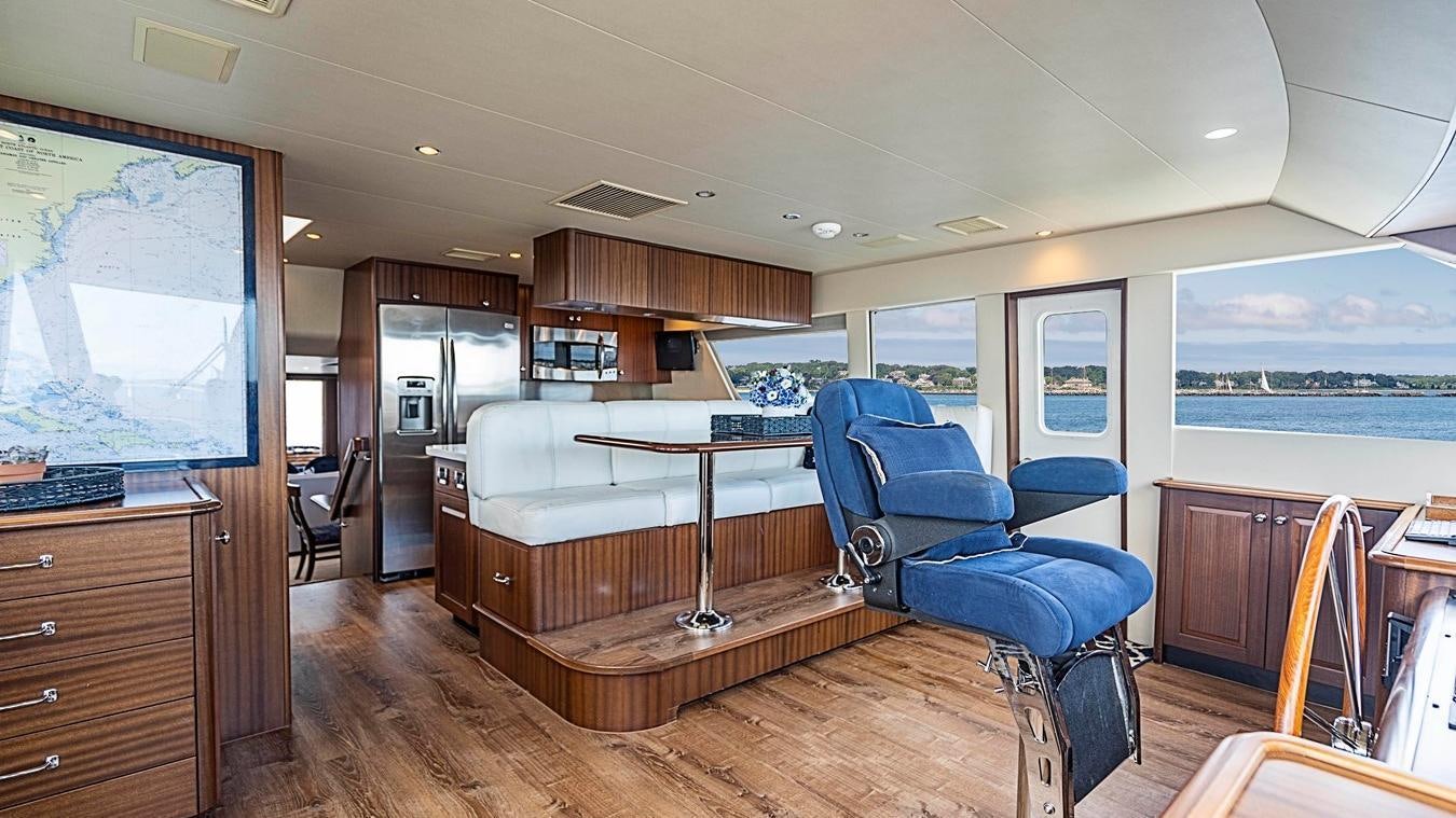 a room with a large window and a wood floor aboard TRANQUILITY Yacht for Charter