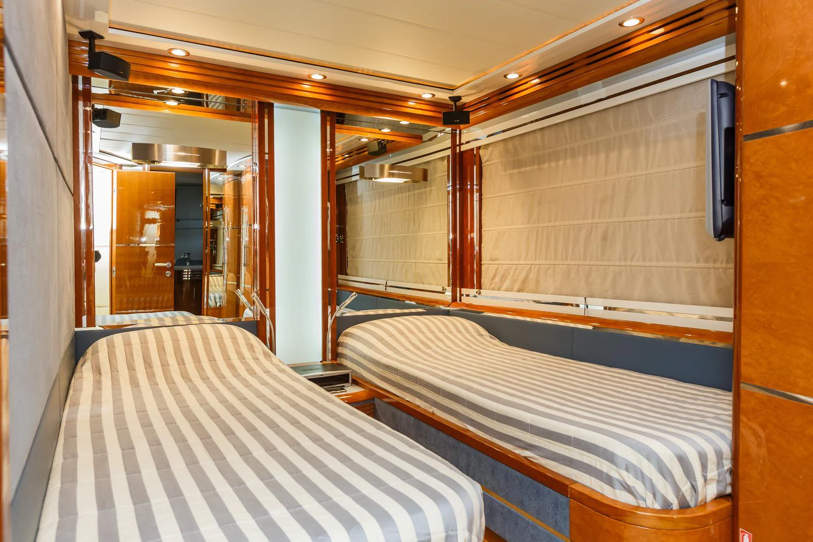 a room with beds and a window aboard KAIROS II Yacht for Charter