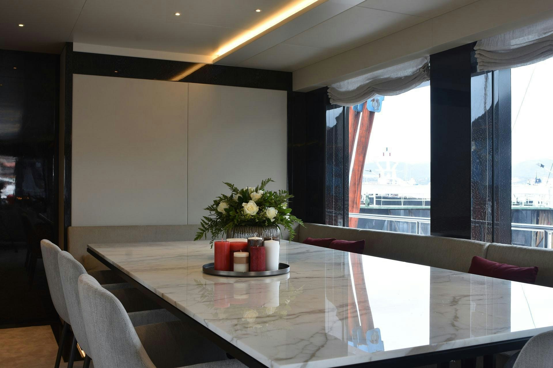 a table with candles and flowers on it aboard MY EDEN Yacht for Charter