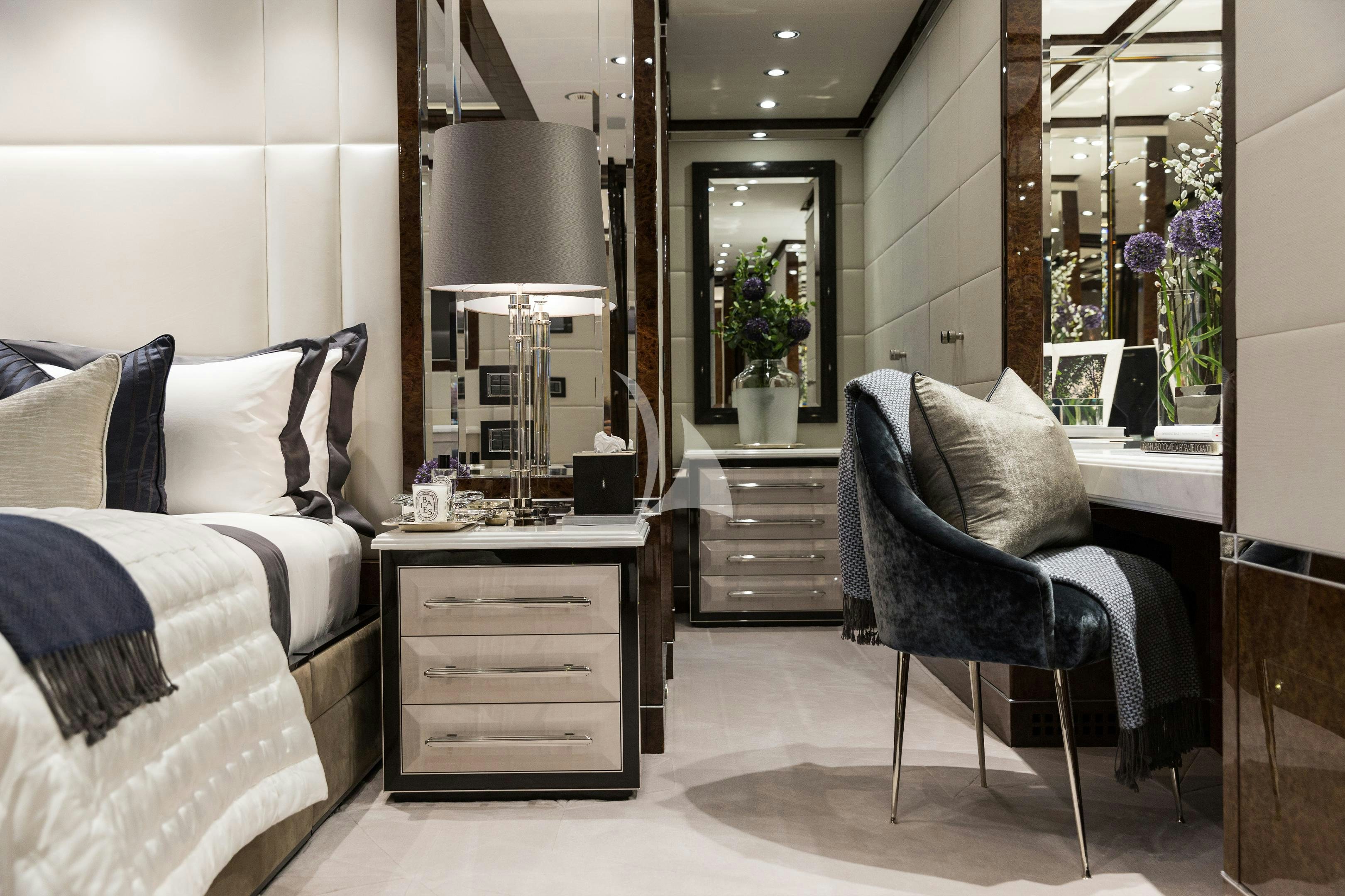 a room with a bed and a desk aboard SOUNDWAVE Yacht for Charter