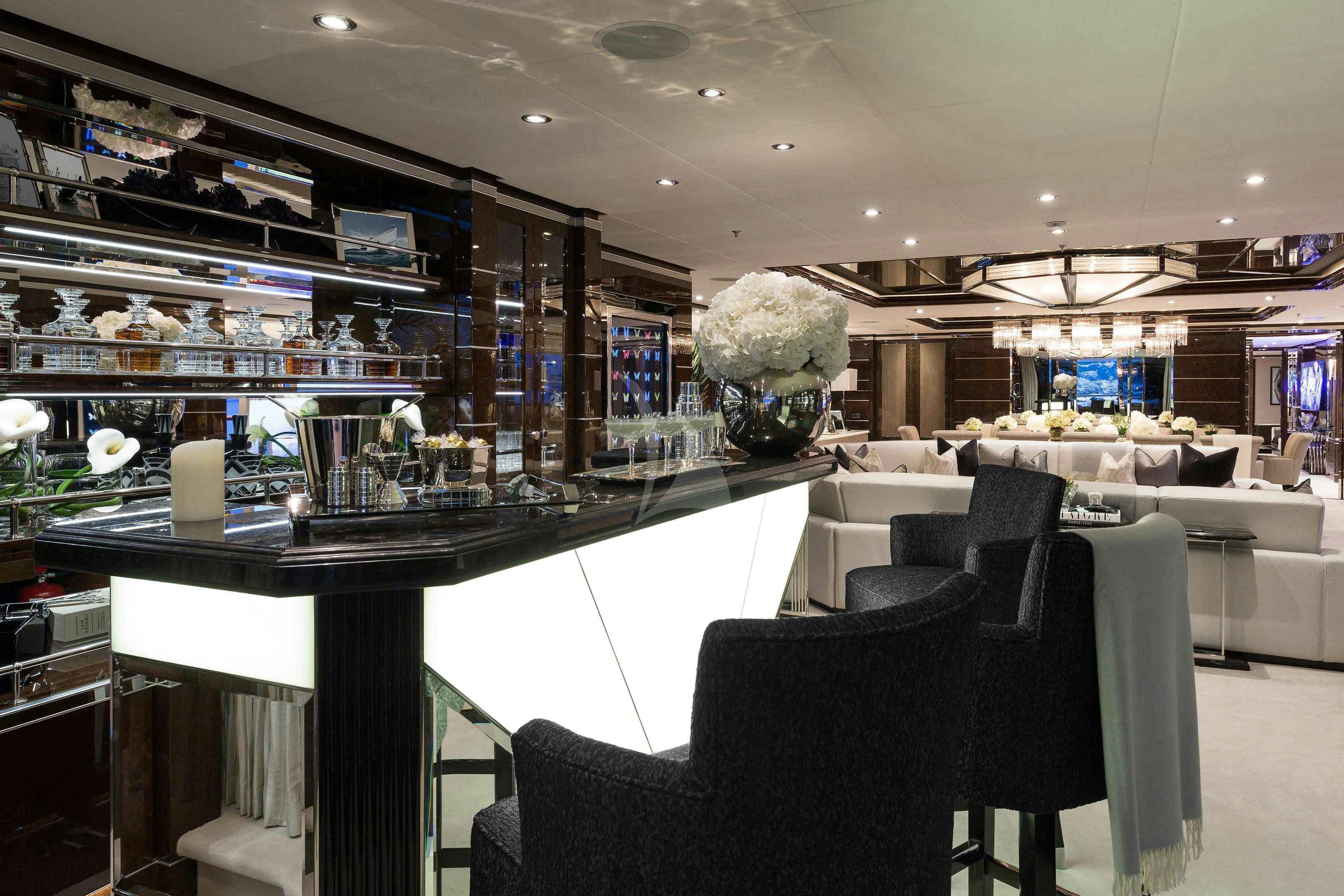 a room with a large glass display case and a black chair aboard SOUNDWAVE Yacht for Charter