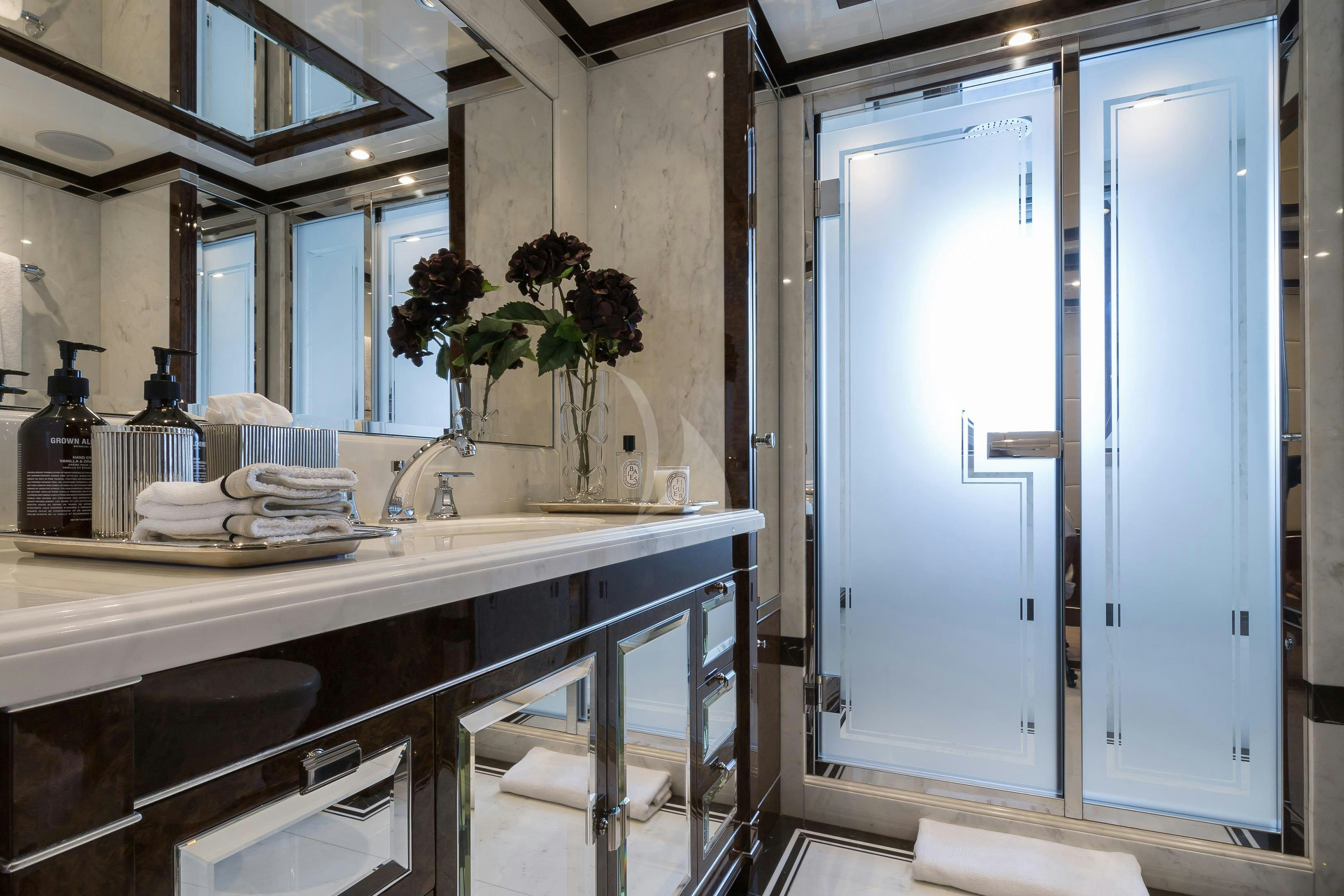 a bathroom with a glass door aboard SOUNDWAVE Yacht for Charter