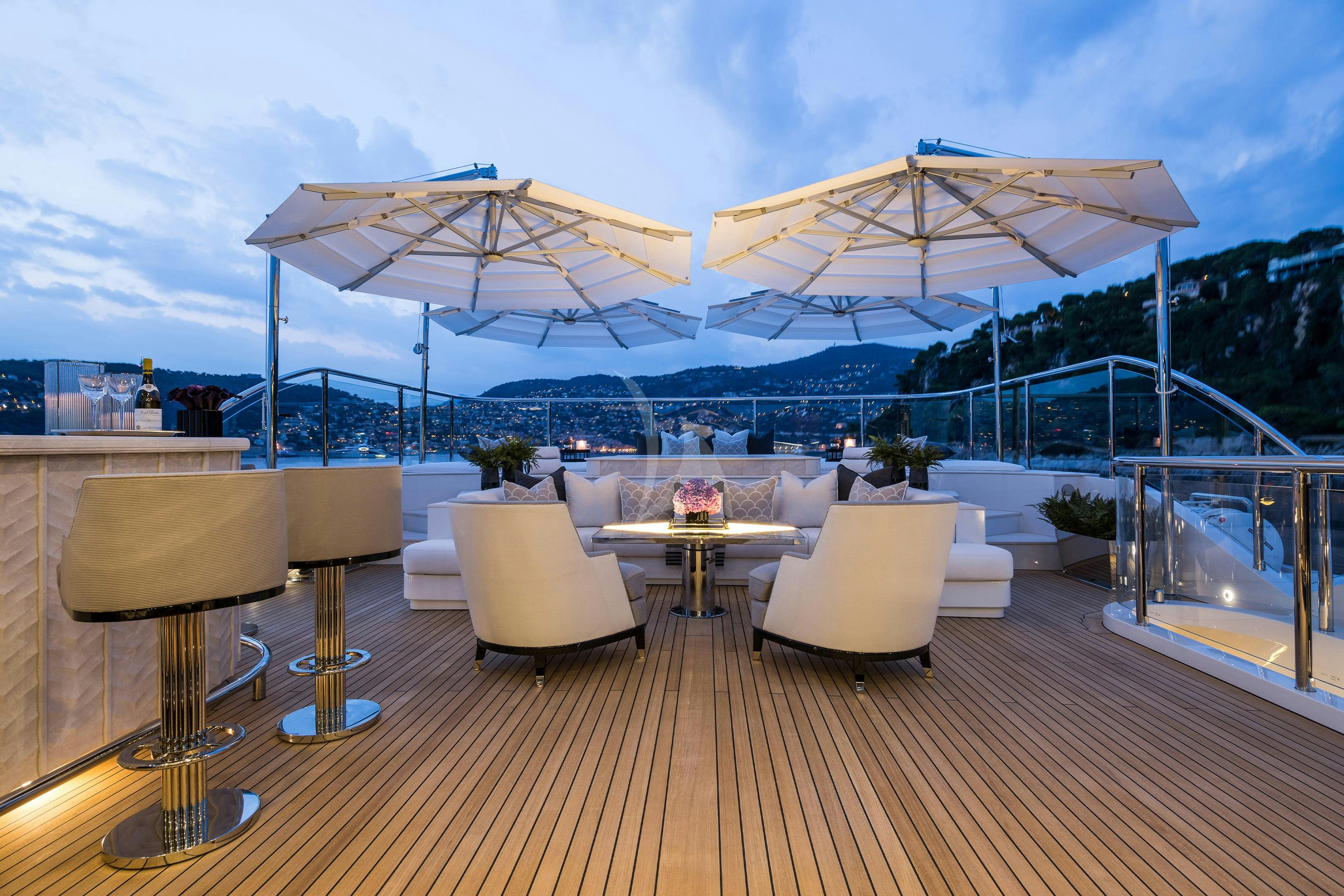 a patio with a table and chairs aboard SOUNDWAVE Yacht for Charter