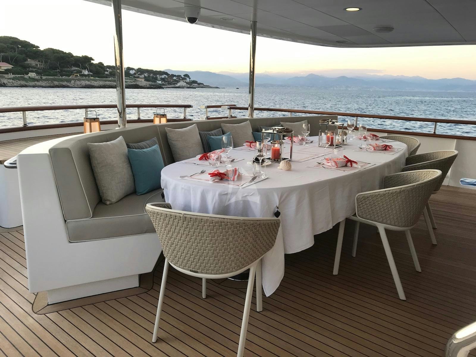 a table and chairs on a patio aboard CORNELIA Yacht for Charter