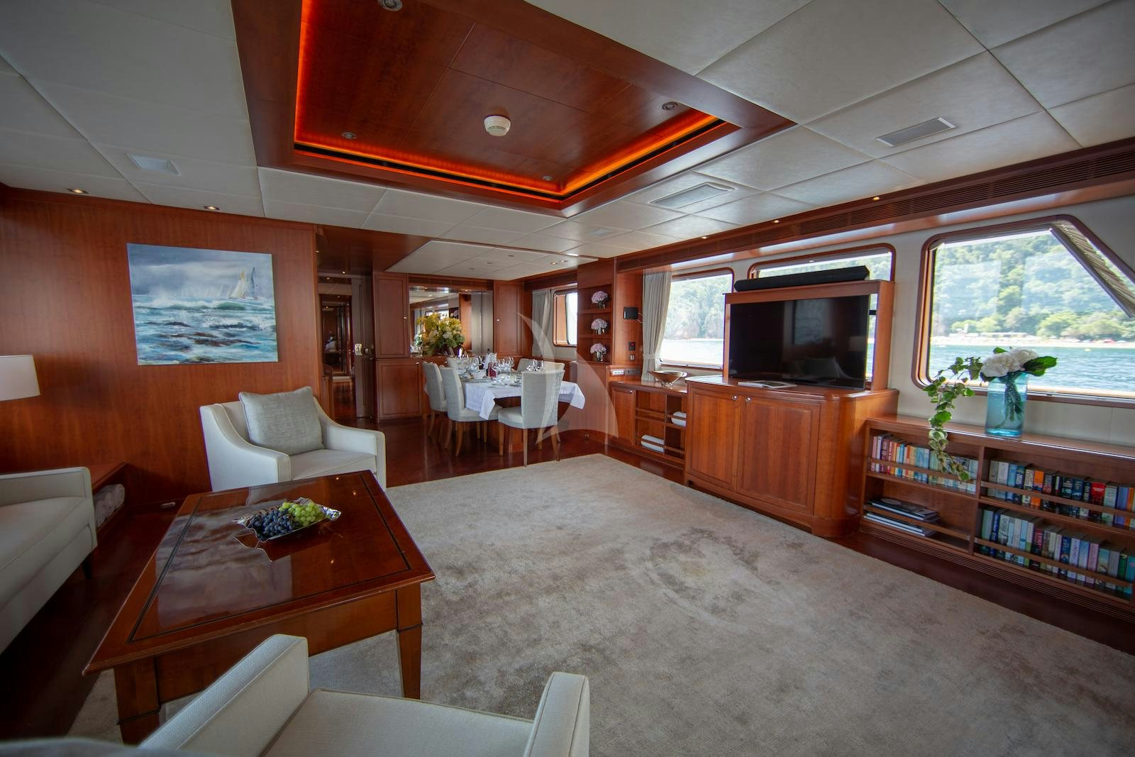 a living room with a large screen aboard CORNELIA Yacht for Charter
