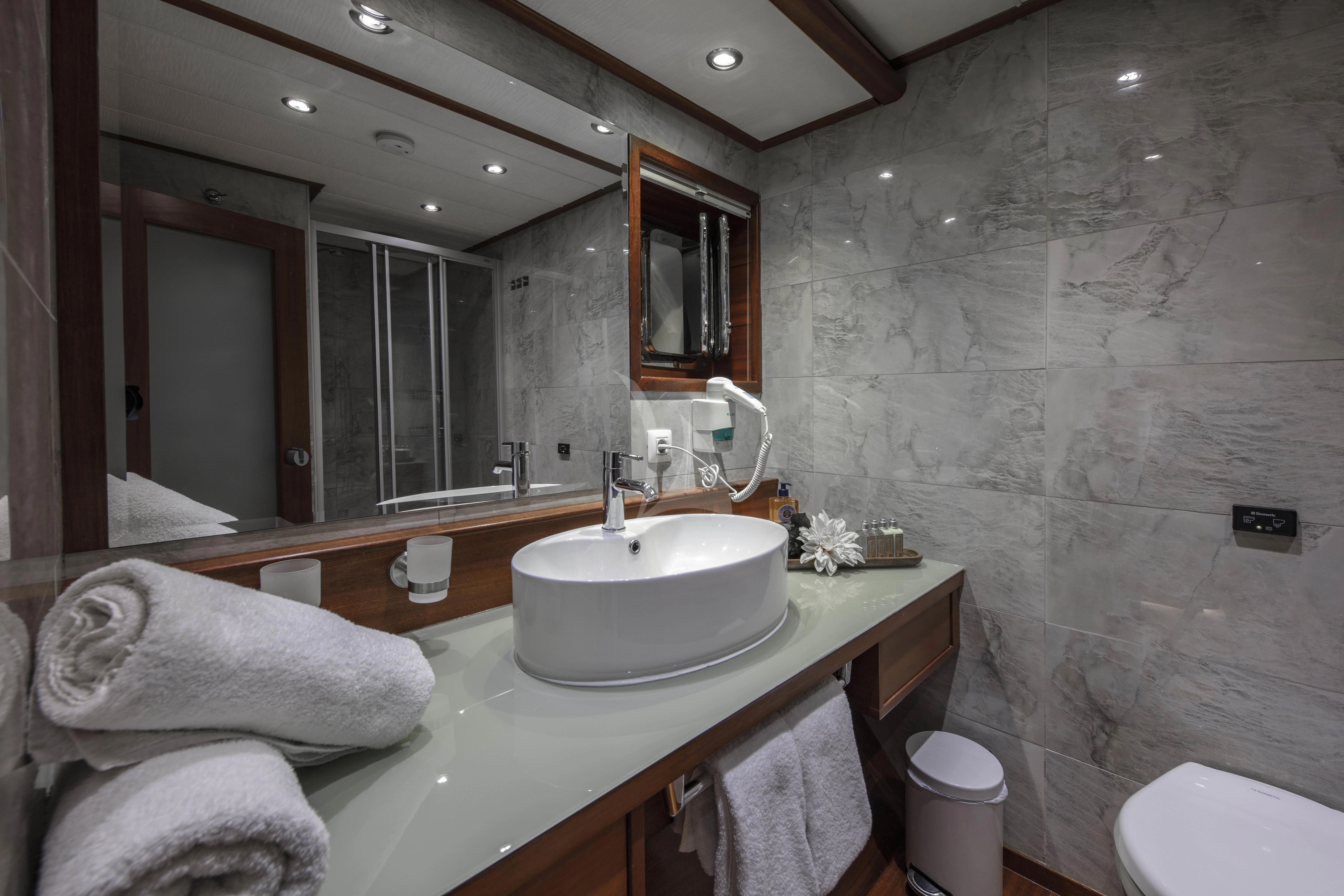 a bathroom with a large mirror aboard ALESSANDRO I Yacht for Charter