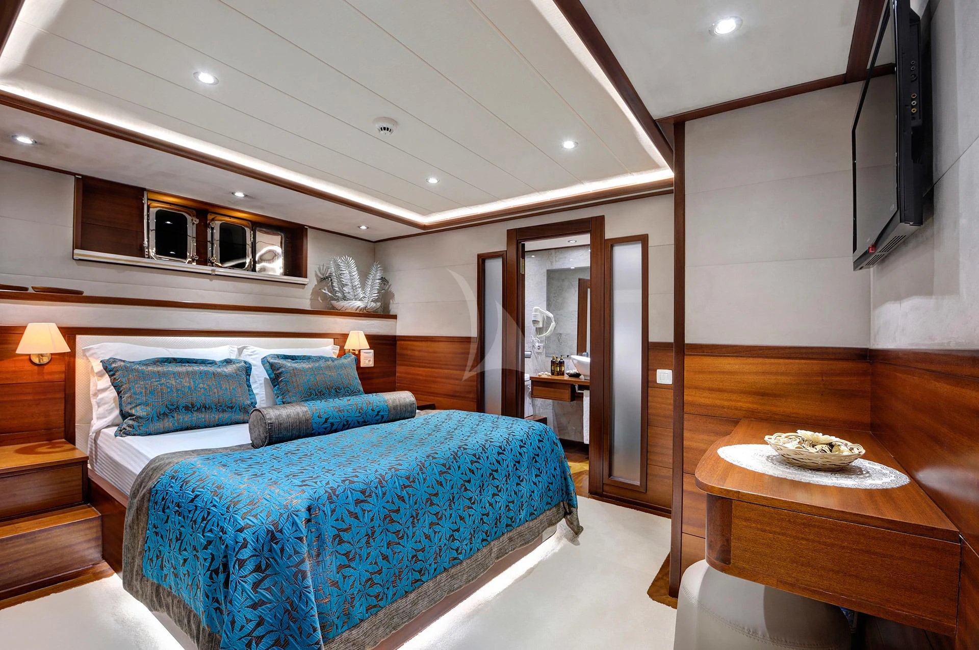 a bedroom with a bed and a desk aboard ALESSANDRO I Yacht for Charter