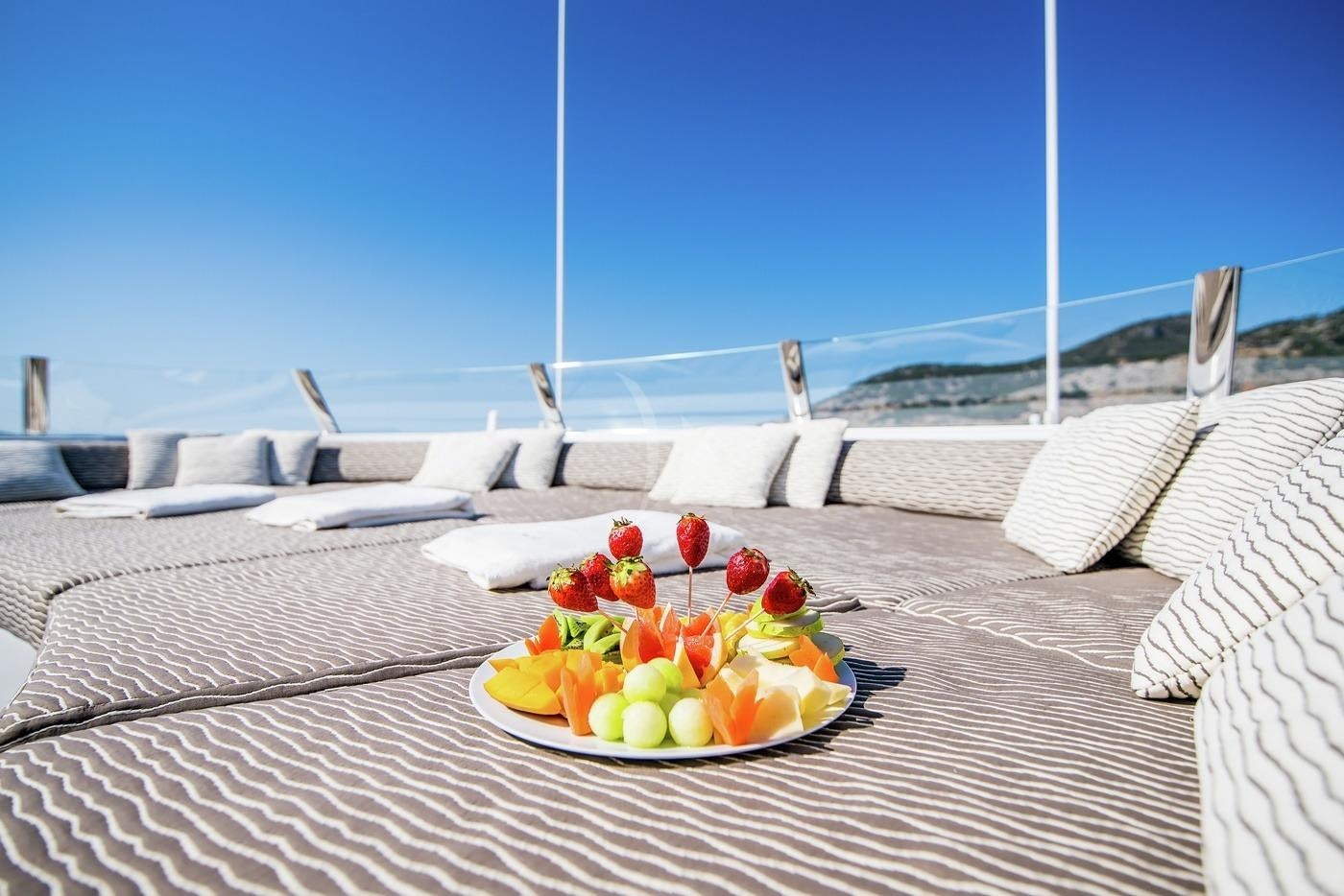 a plate of food on a table aboard AZIZA Yacht for Charter