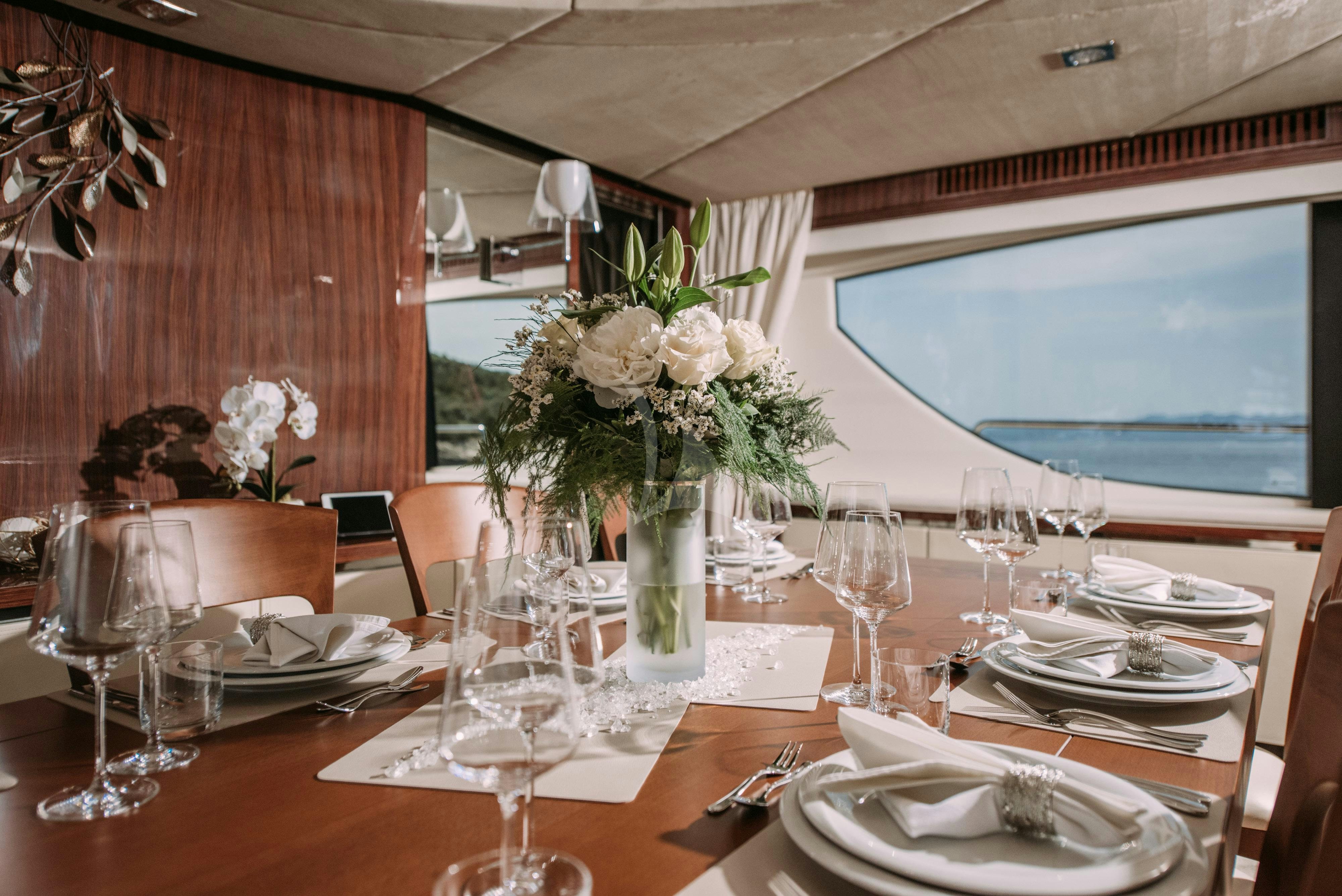 a table with plates and glasses aboard ARTEMY Yacht for Charter