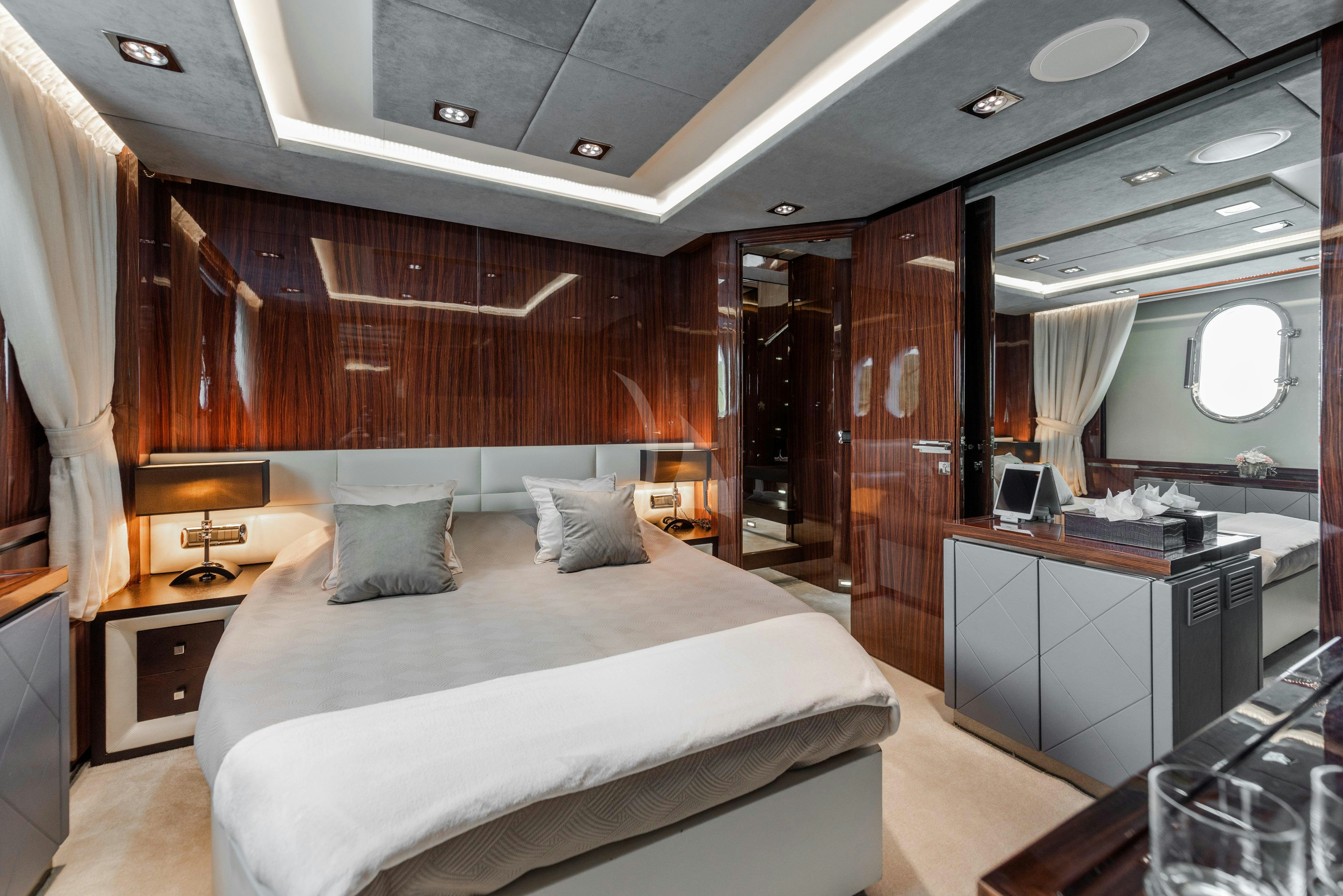 a room with a bed and a desk aboard ARTEMY Yacht for Charter