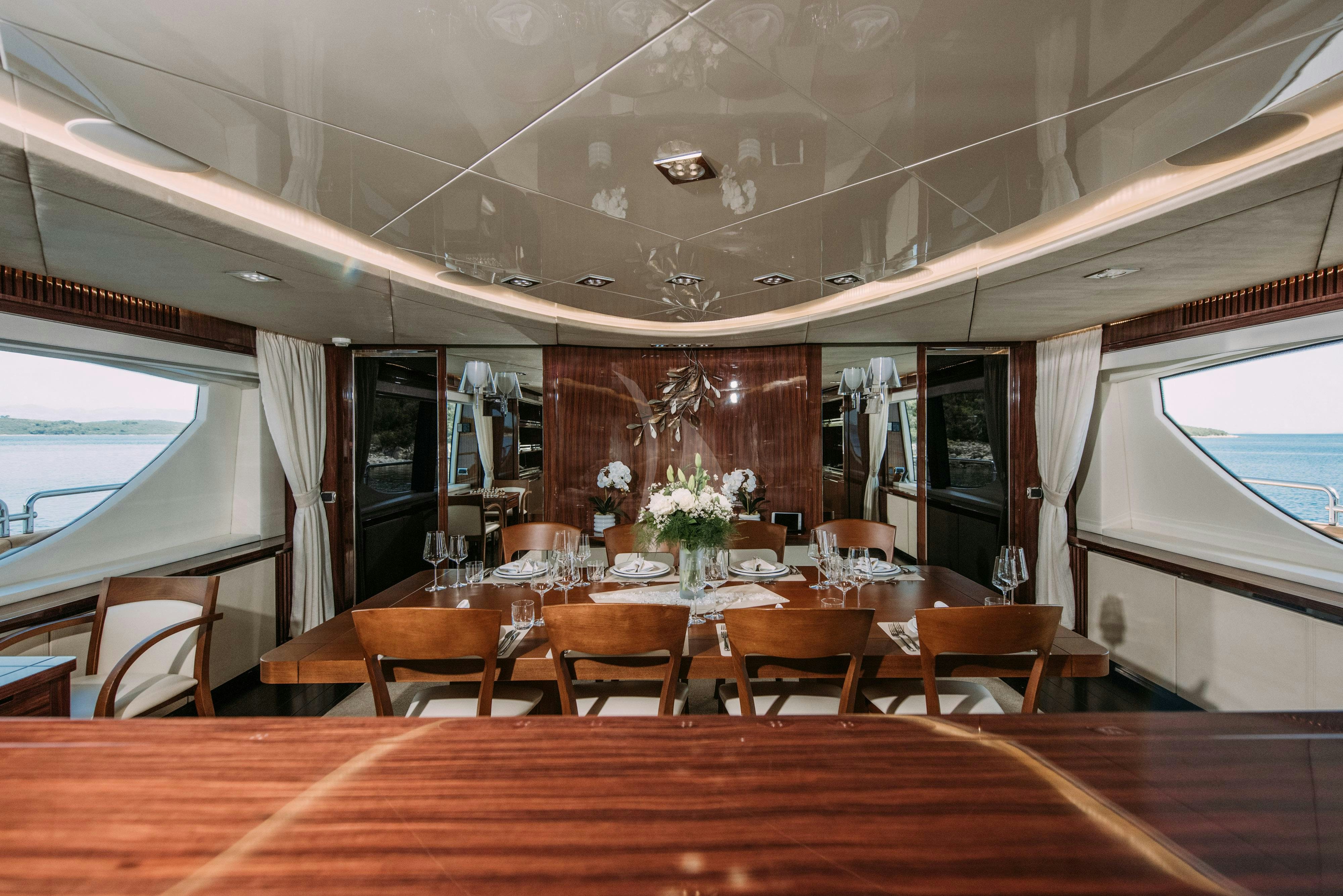 a room with tables and chairs aboard ARTEMY Yacht for Charter