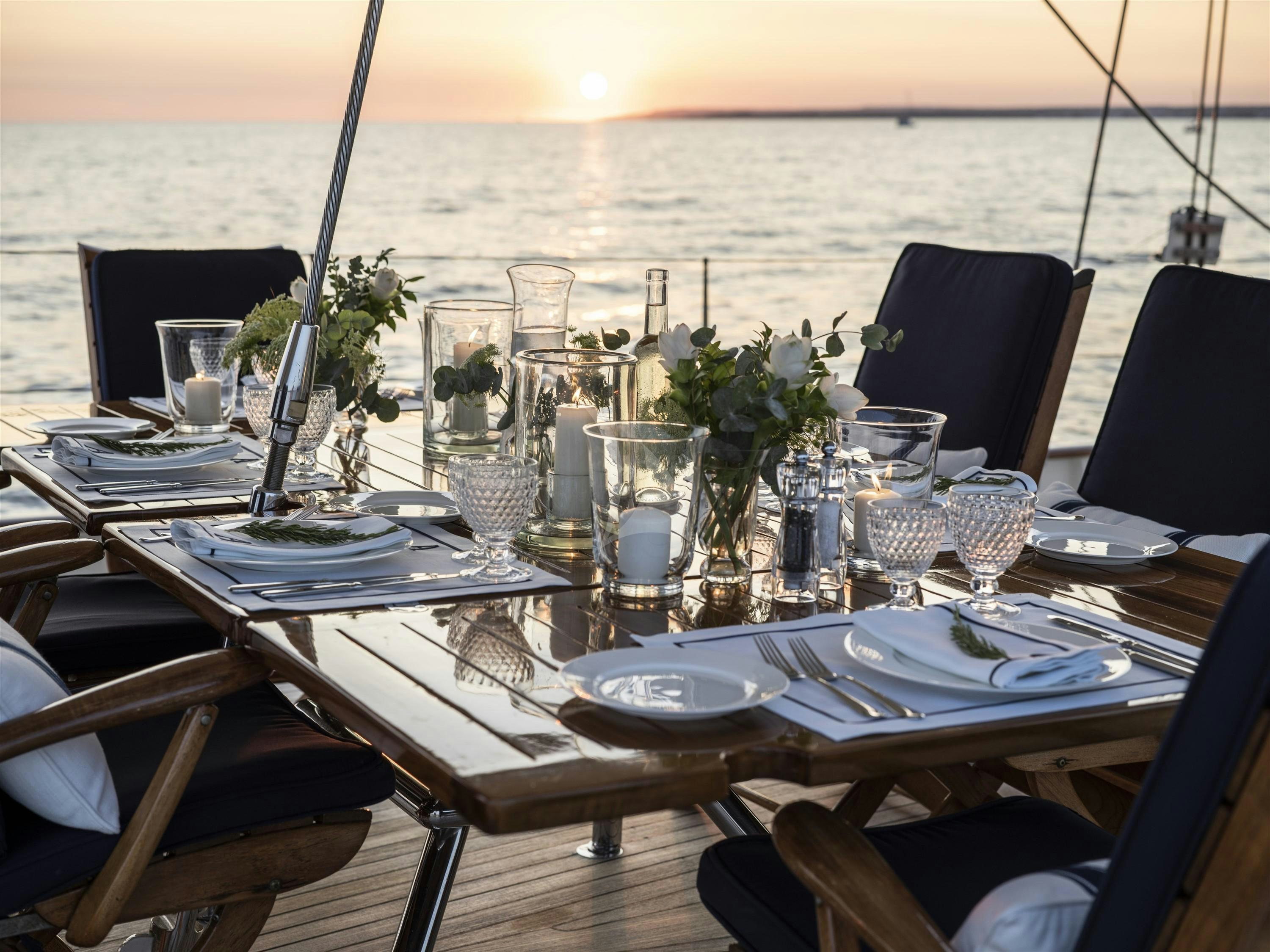 a table set for a dinner aboard ALEXA OF LONDON Yacht for Charter