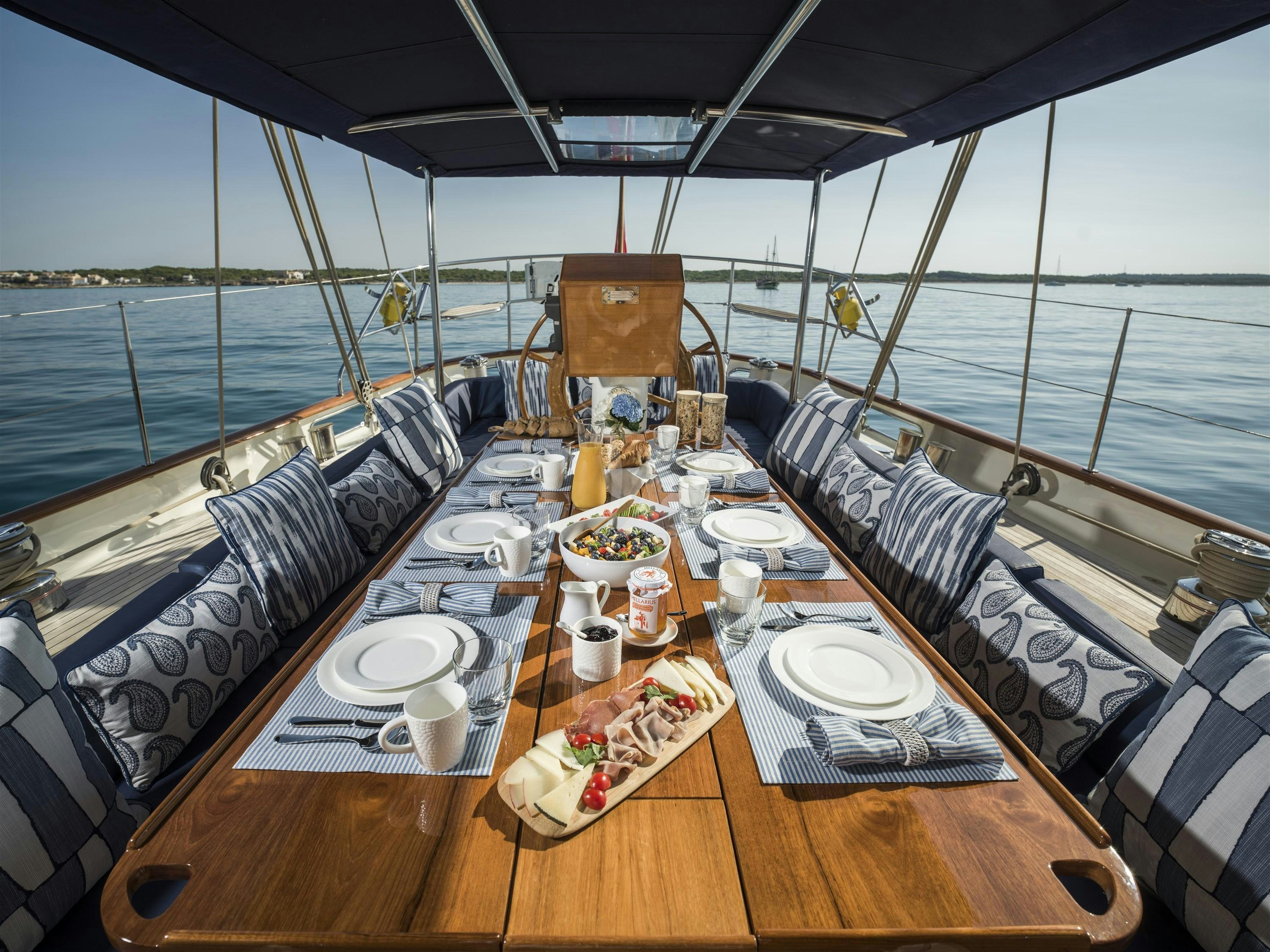 a table with plates and cups on it aboard ALEXA OF LONDON Yacht for Charter