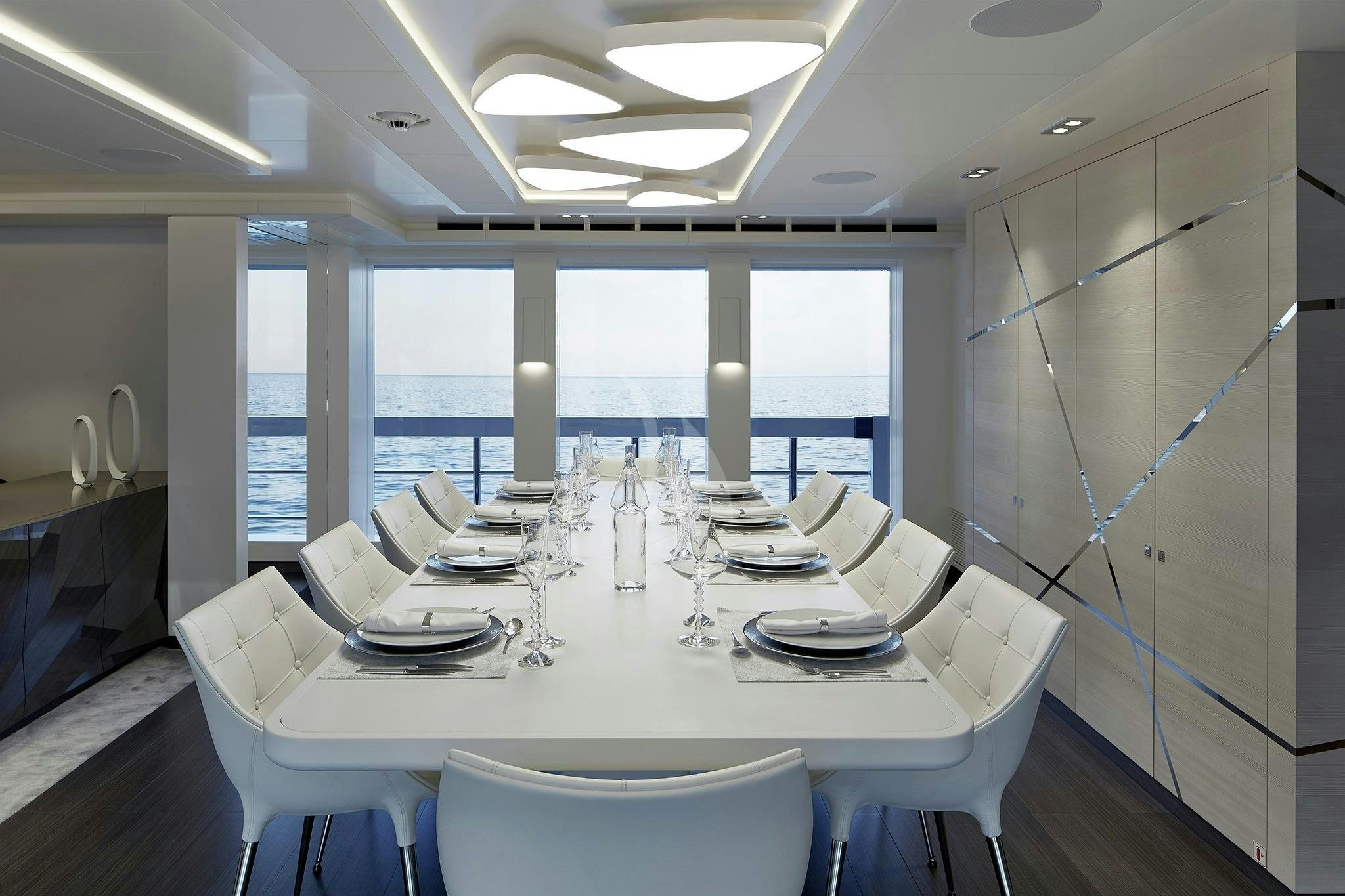 a large white dining table aboard HOME Yacht for Sale