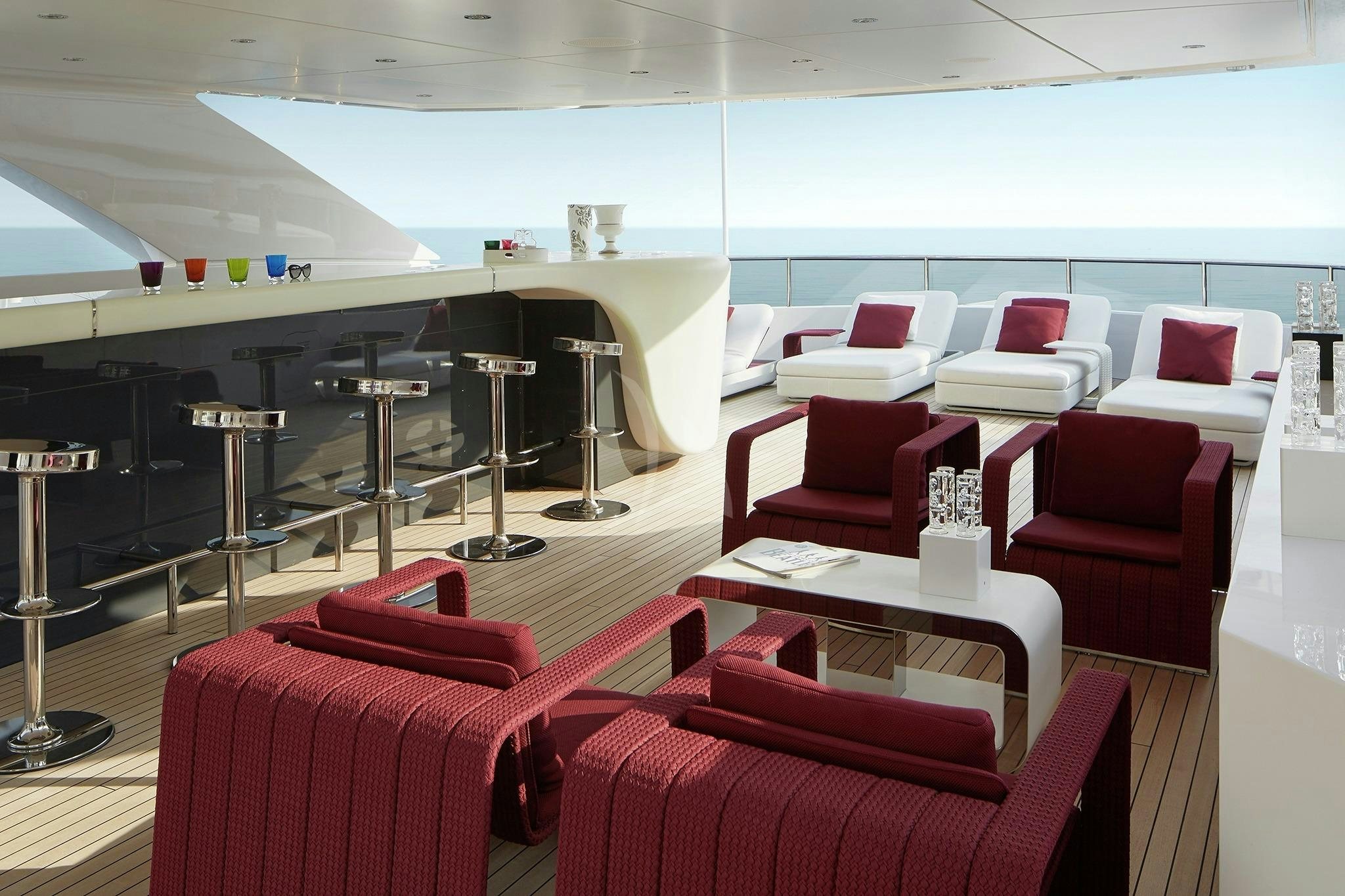 a room with chairs and tables aboard HOME Yacht for Sale