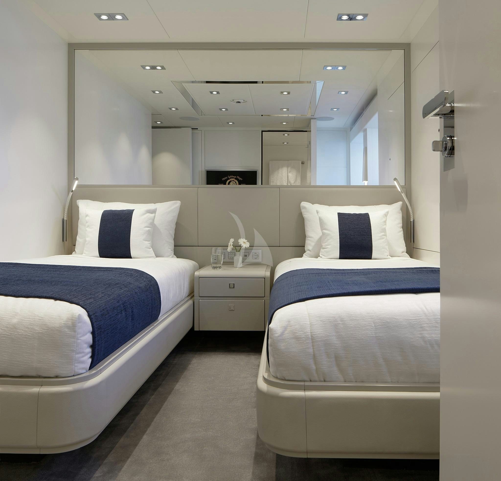 a room with white beds aboard HOME Yacht for Sale