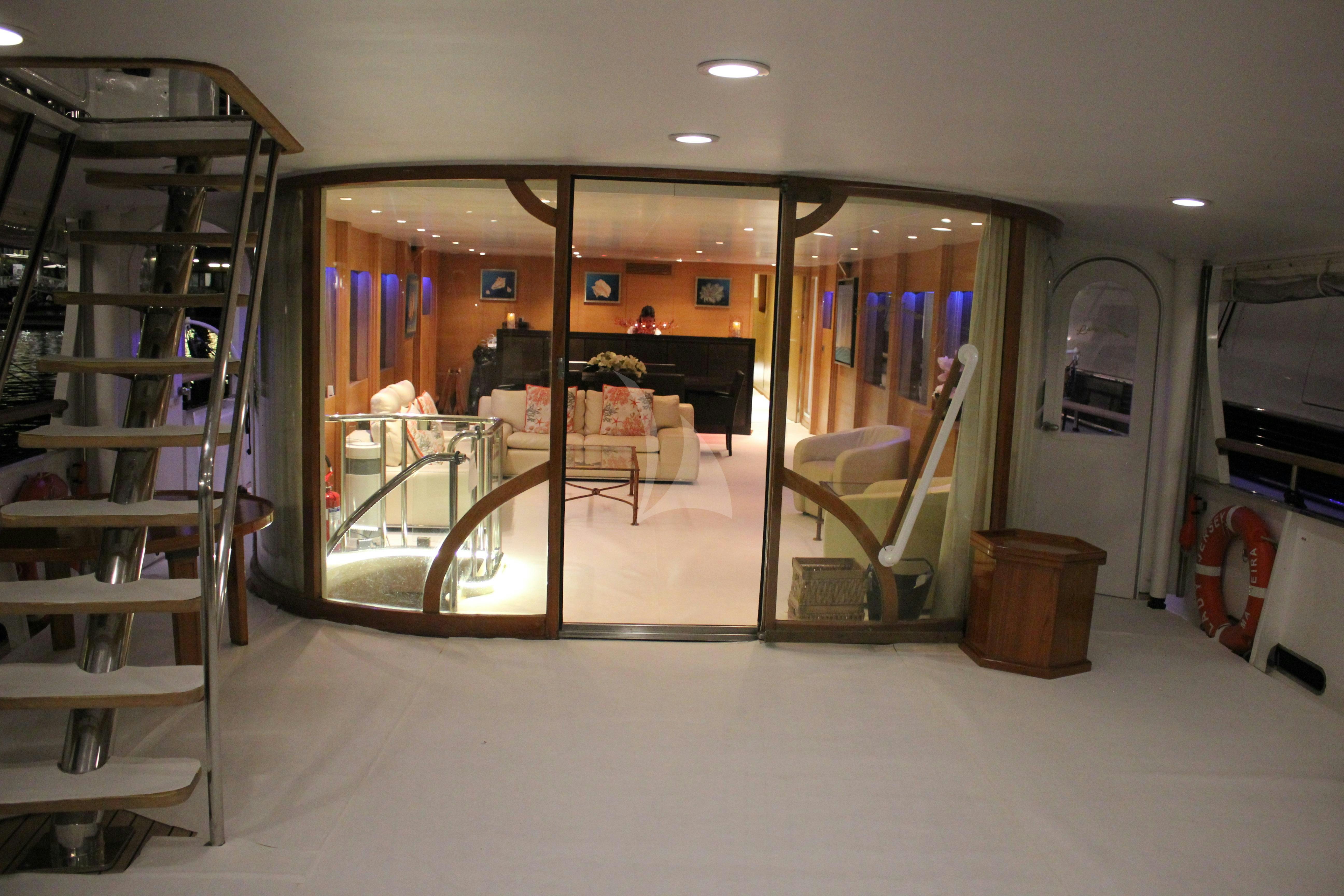 a room with a glass door and a mirror aboard LADY JERSEY Yacht for Charter