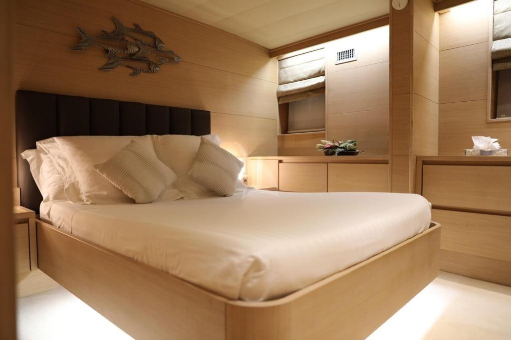 a bed with white sheets aboard LADY JERSEY Yacht for Charter