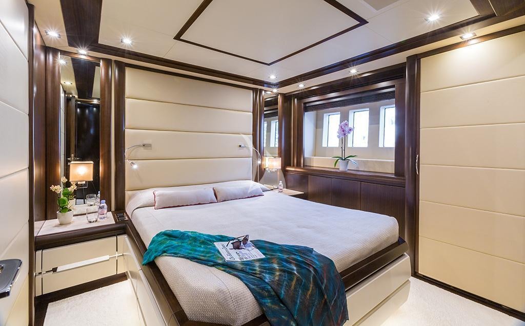 a bedroom with a bed and a mirror aboard GATSBY Yacht for Charter