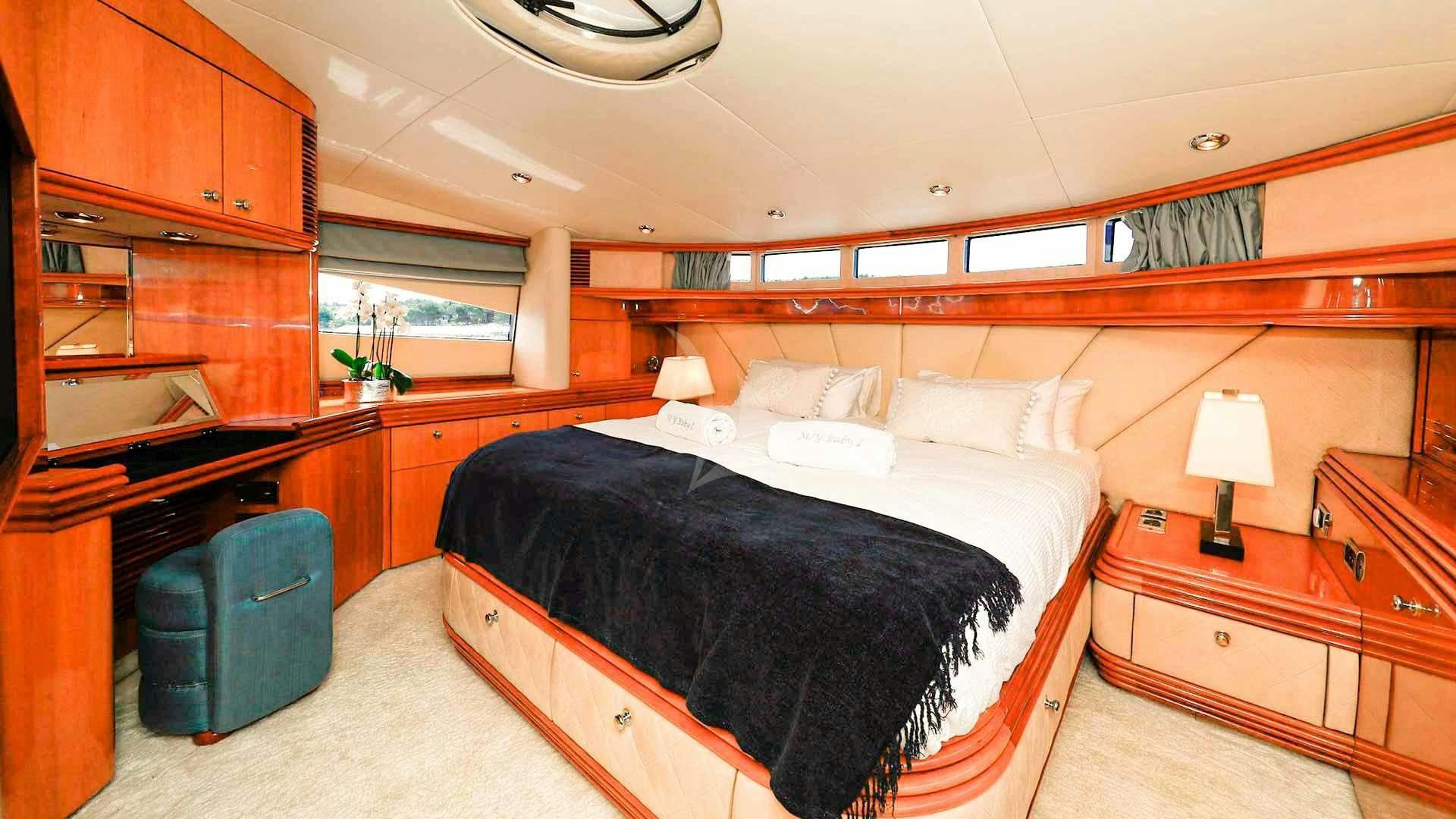 a bedroom with a bed and a desk aboard BABY I Yacht for Charter