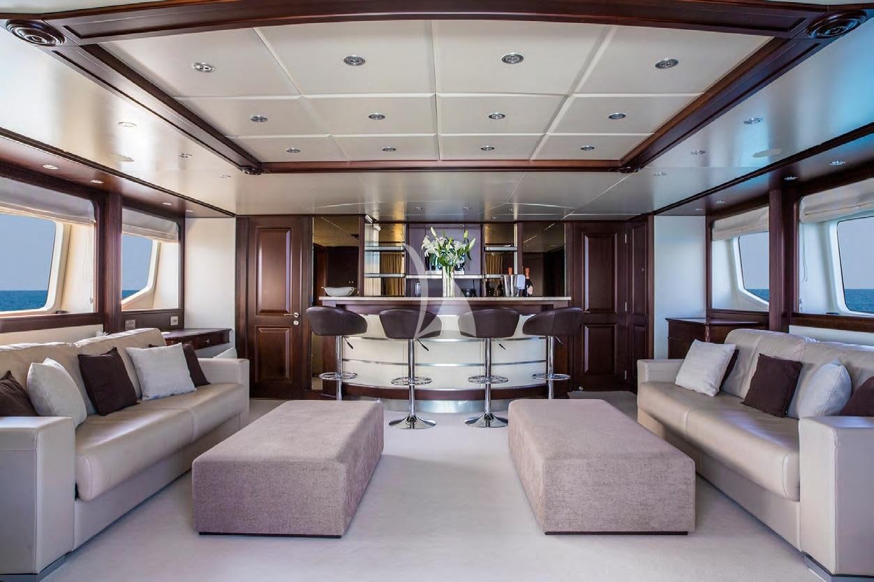 a living room with a table and couches aboard FRIENDSHIP Yacht for Charter
