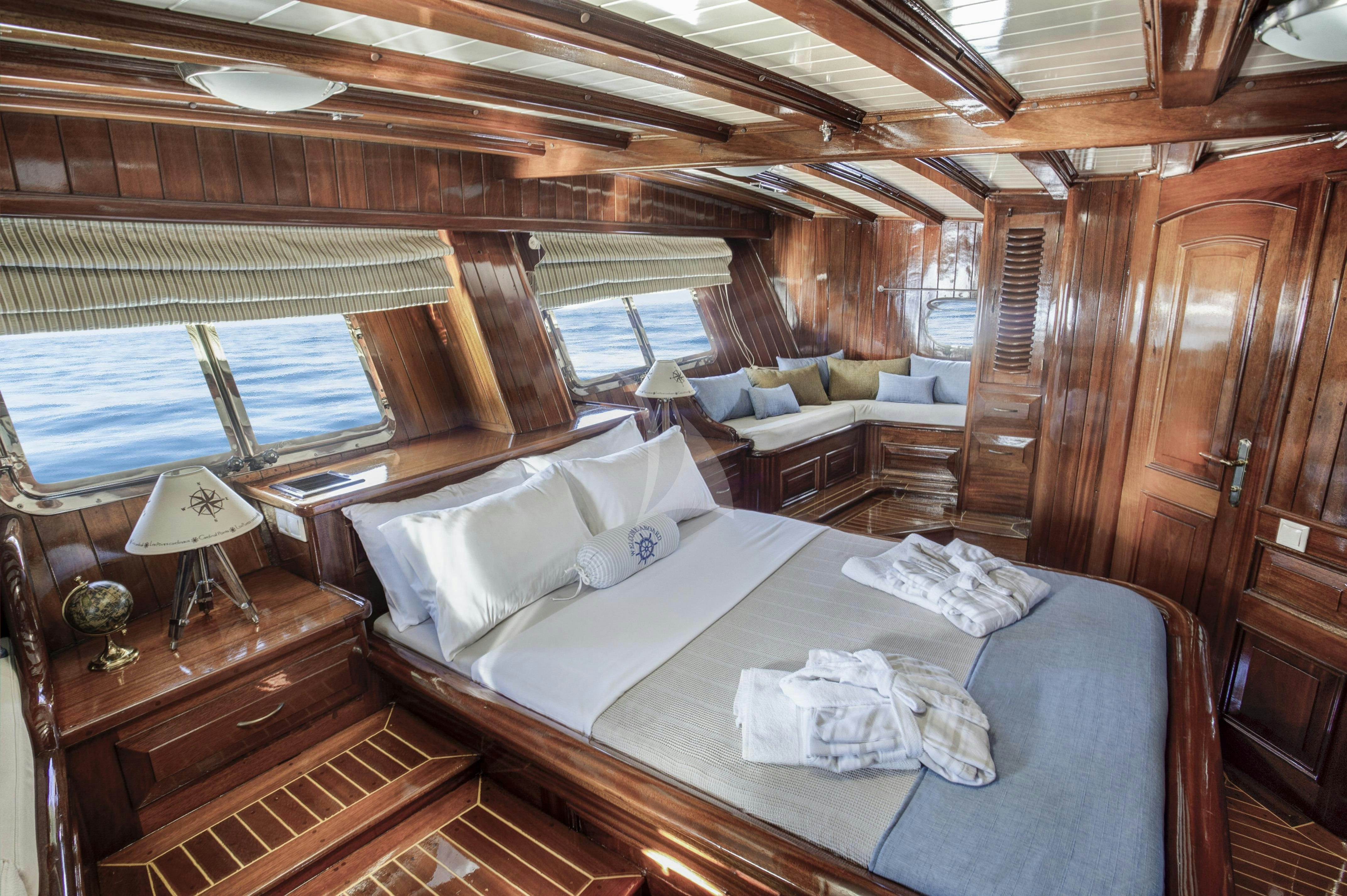 a room with a bed and a couch aboard ENTRE CIELOS Yacht for Charter