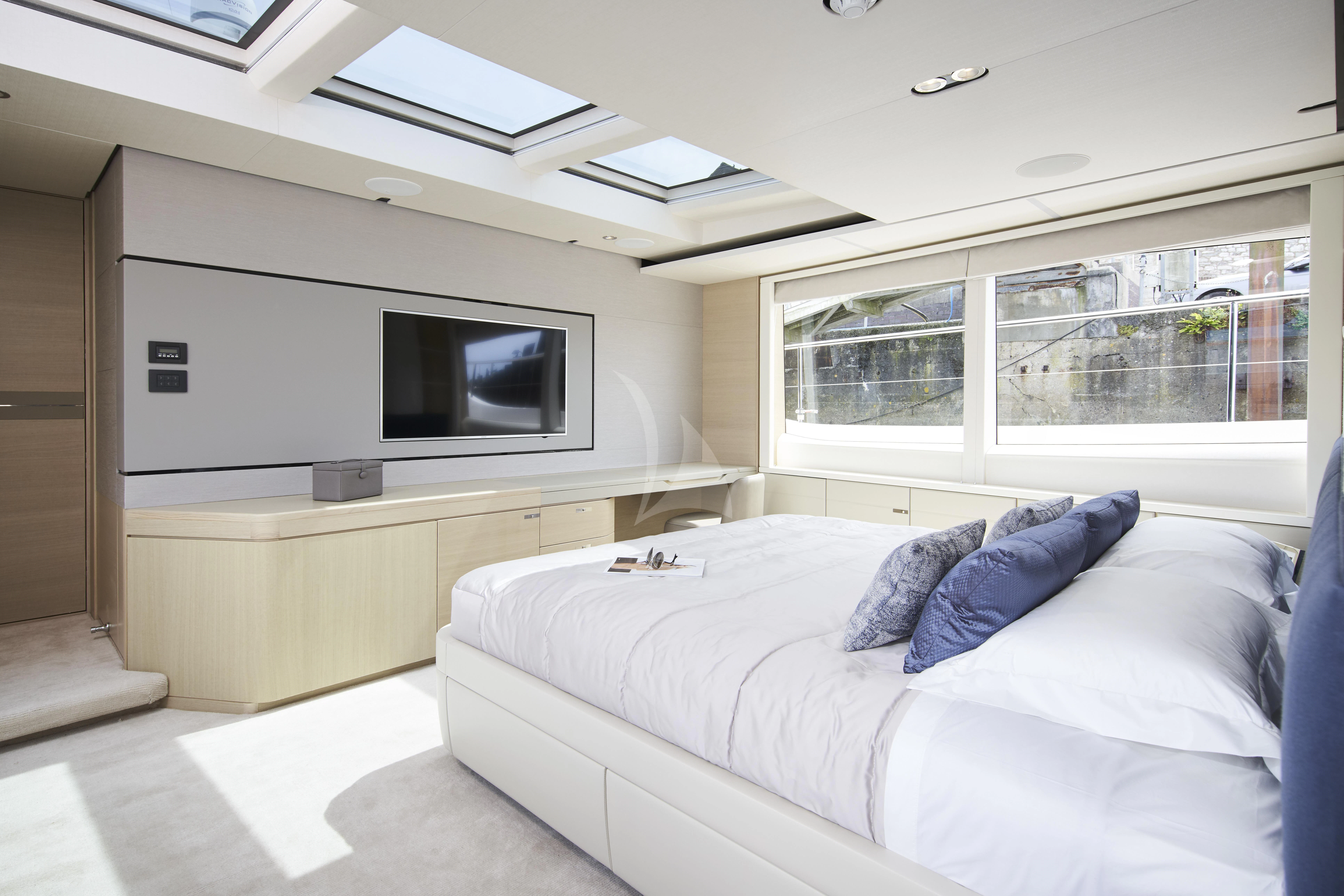 a room with a bed and a tv aboard HALLELUJAH Yacht for Charter