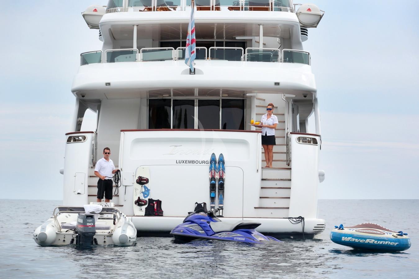 a couple of men standing on a boat on the water aboard INOUIS Yacht for Charter