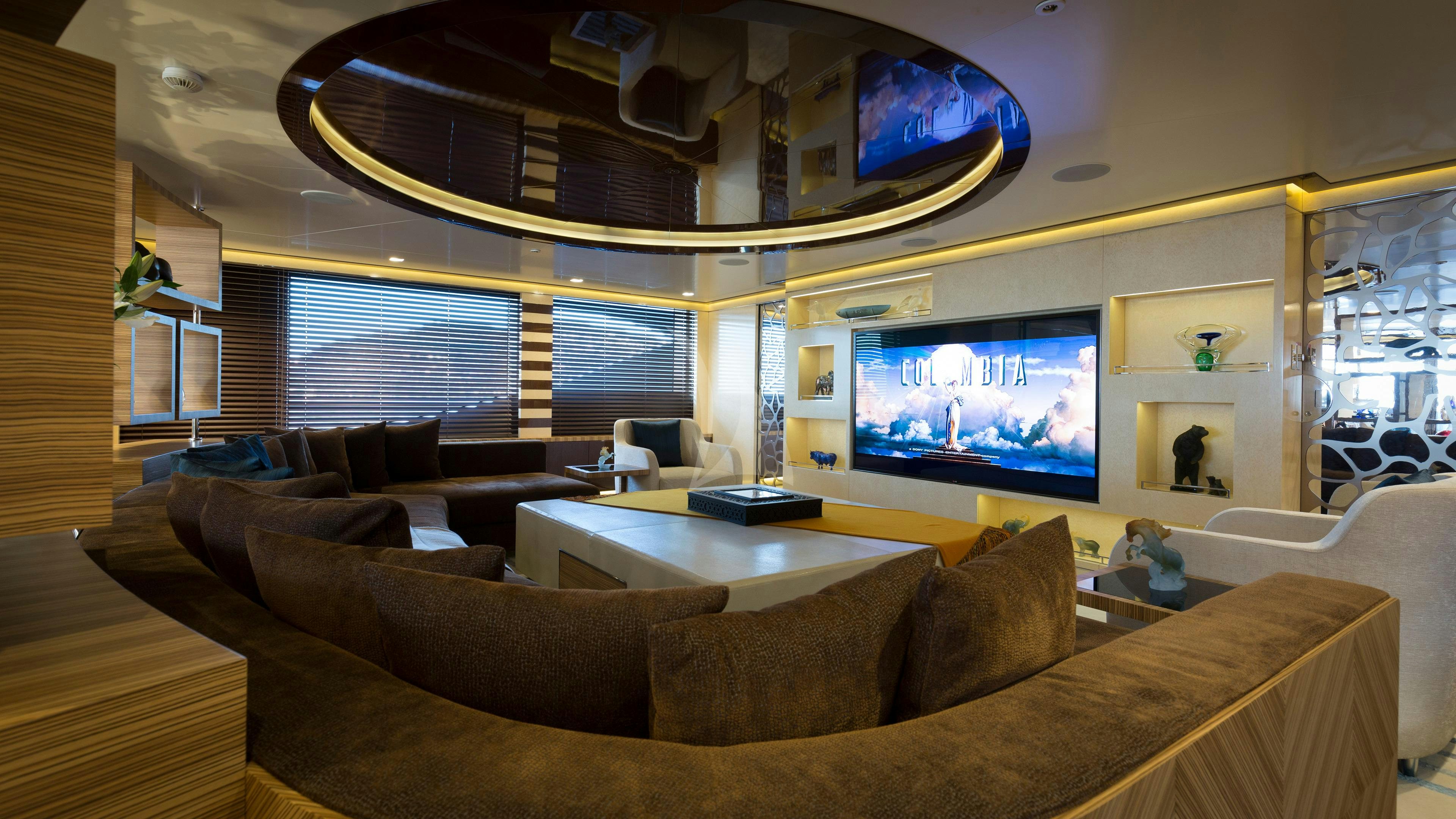 a living room with a large screen aboard TAIBA Yacht for Charter