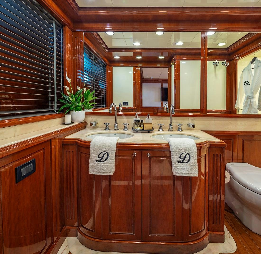 a bathroom with wooden cabinets aboard DIVINE Yacht for Charter