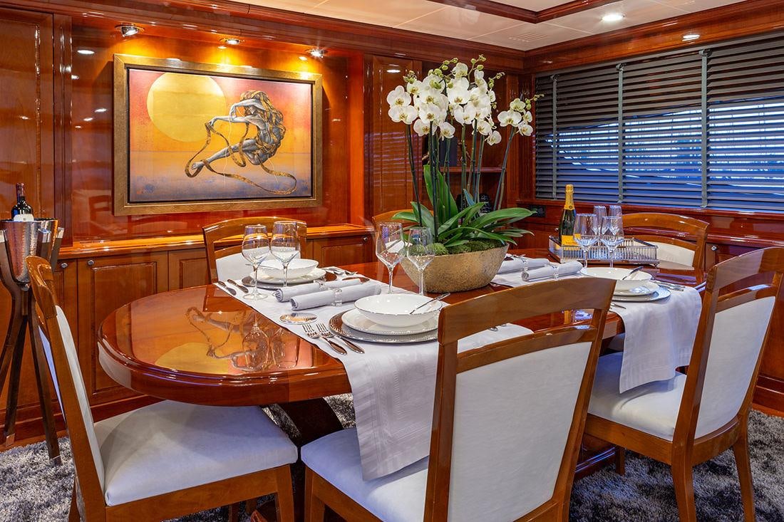 a table set with place settings aboard DIVINE Yacht for Charter