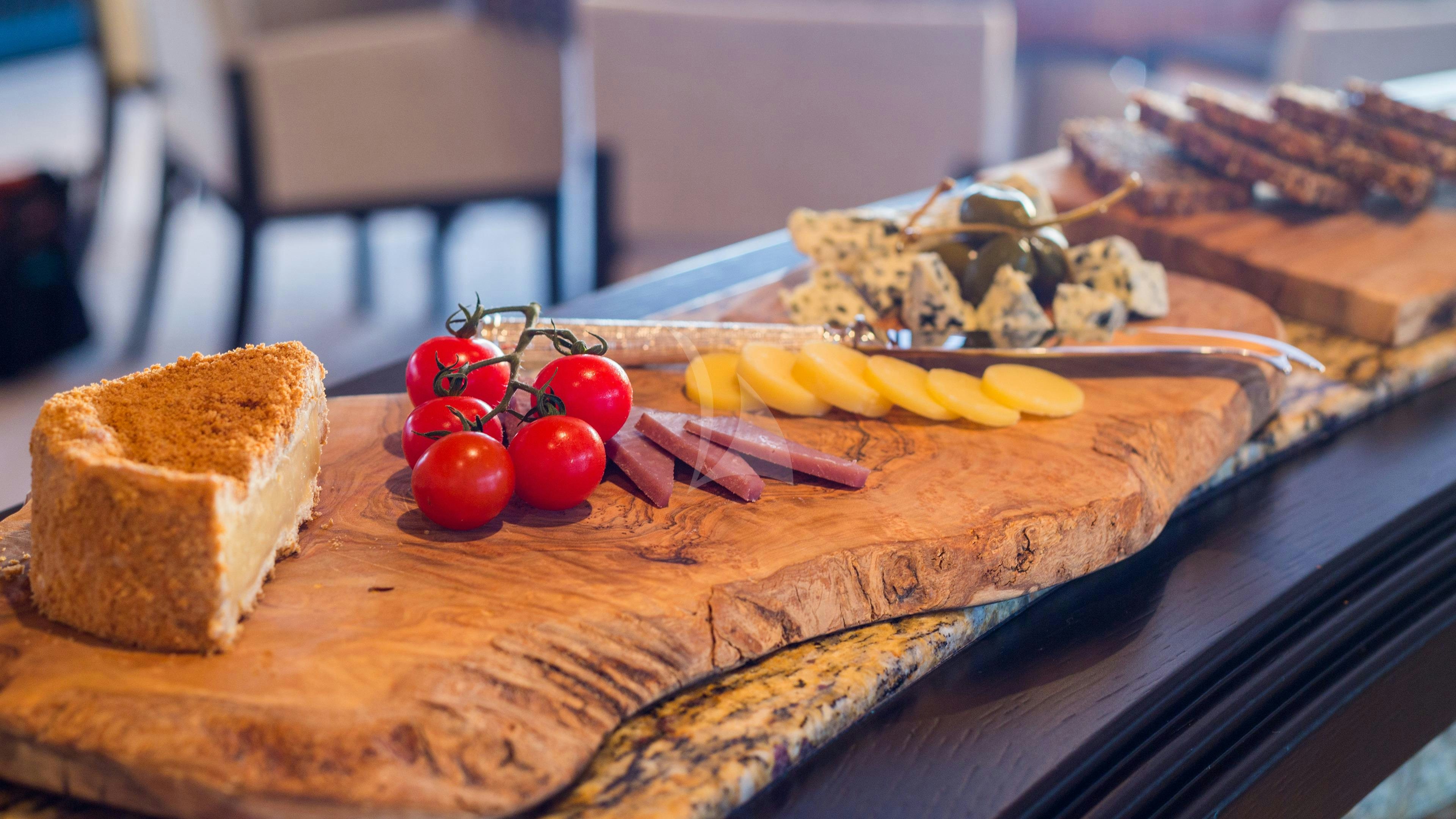 a cutting board with bread and fruits aboard ADVENTURE Yacht for Charter