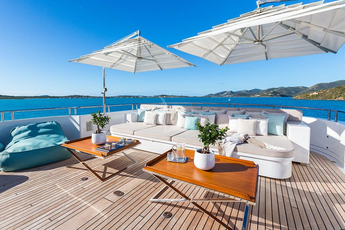 a patio with a table and chairs on it aboard ADVENTURE Yacht for Charter