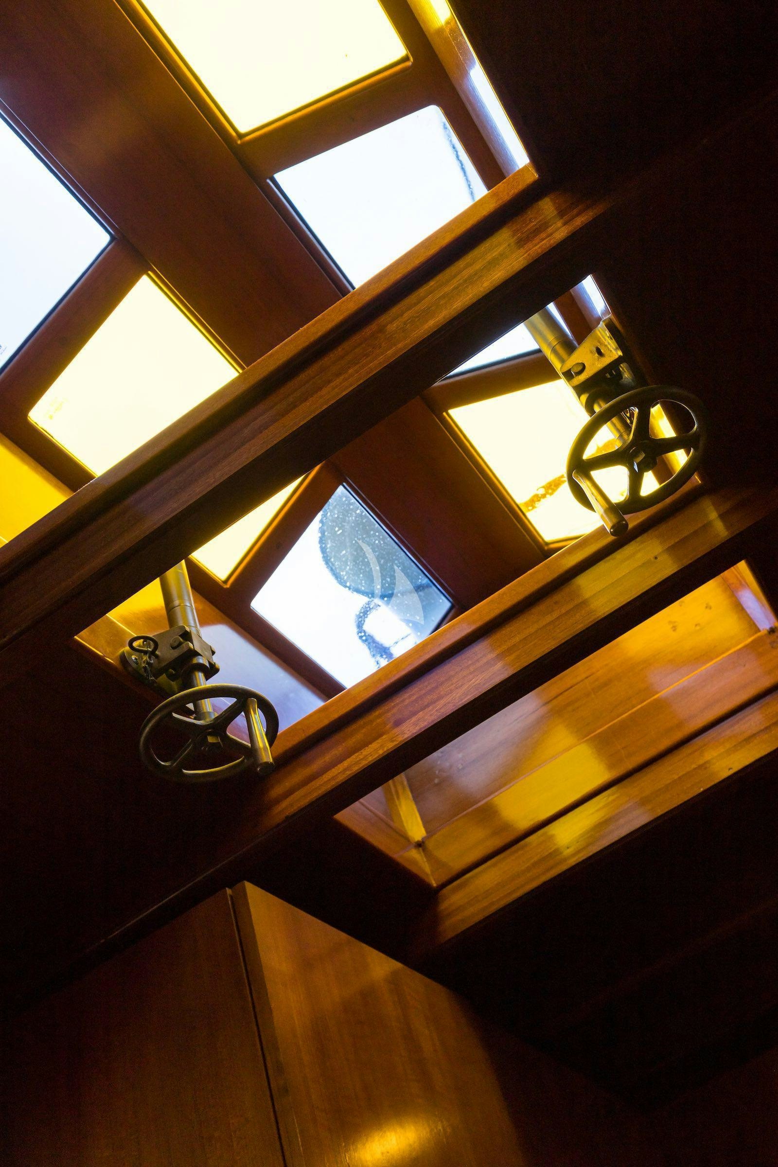 a light fixture on a wooden surface aboard OVER THE RAINBOW OF LONDON Yacht for Charter