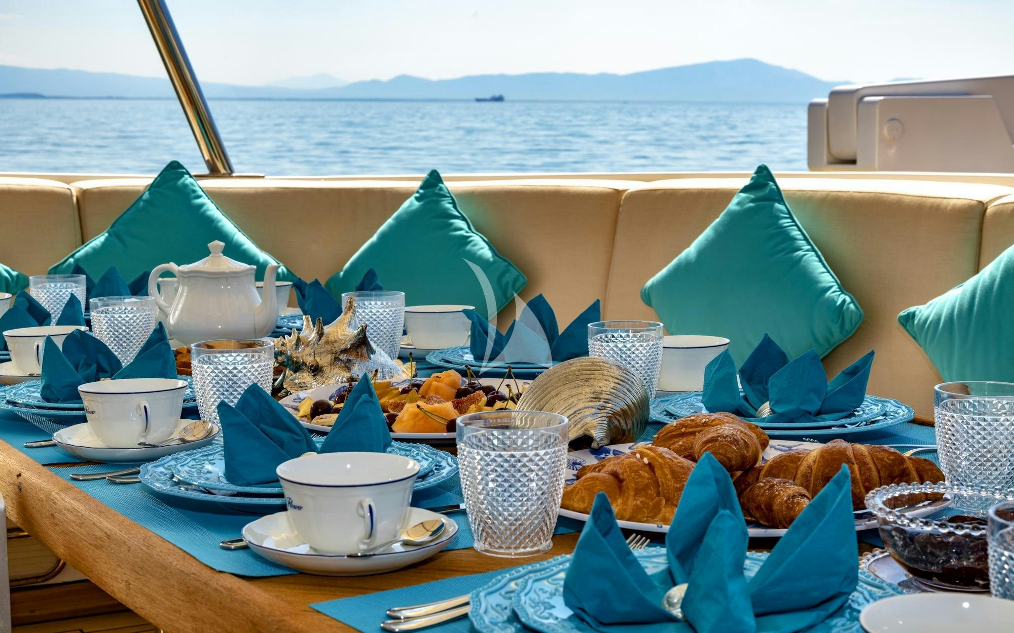 a table with food and drinks on it aboard NIGHTFLOWER Yacht for Charter