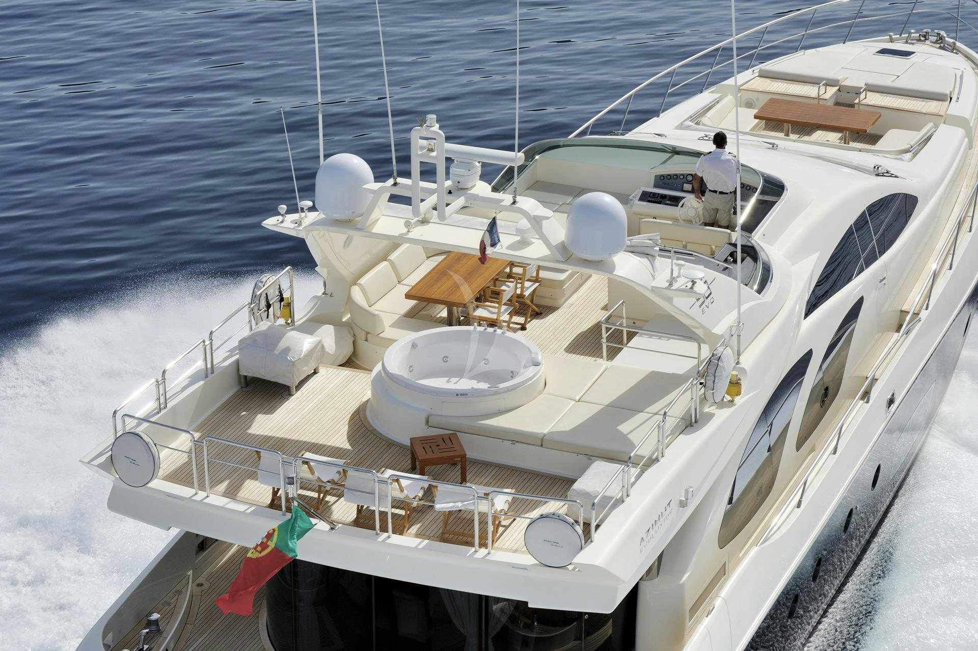 a white boat with a couple of people on it aboard LEONARDO Yacht for Charter