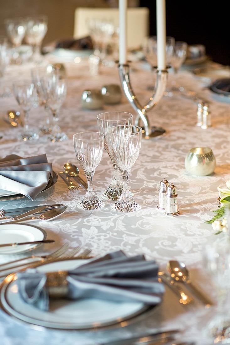 a table with plates and silverware aboard ESMERALDA Yacht for Charter