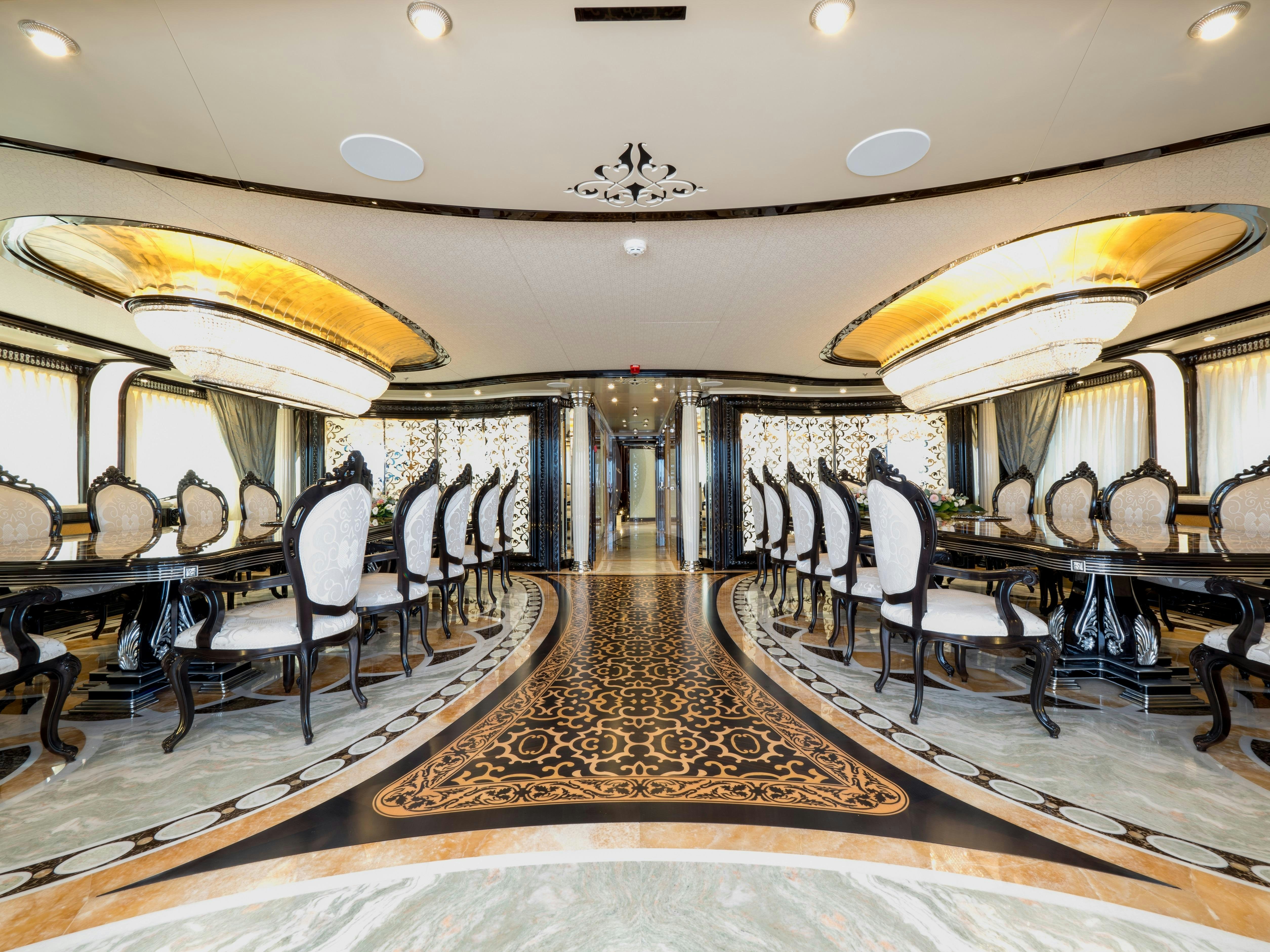 a fancy restaurant with tables and chairs aboard ELEMENTS Yacht for Charter