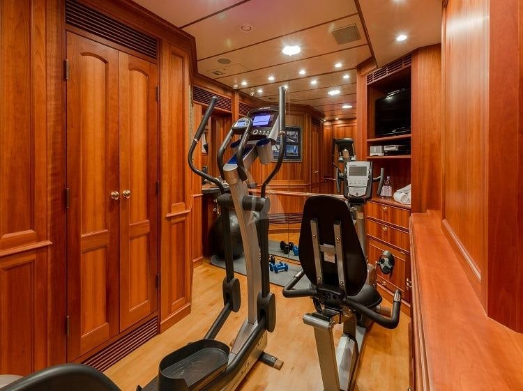a gym with equipment aboard PIONEER Yacht for Charter
