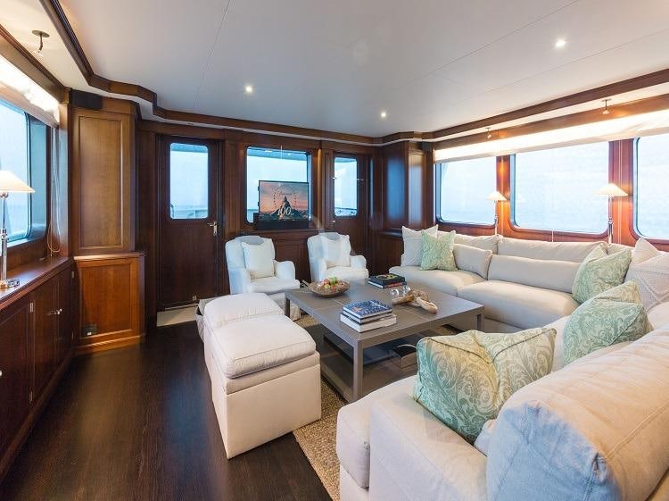 a living room with a couch and a television aboard PIONEER Yacht for Charter