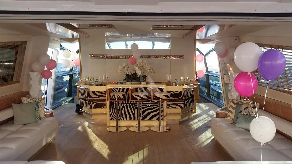 a room with balloons and a table aboard ASTRO Yacht for Charter