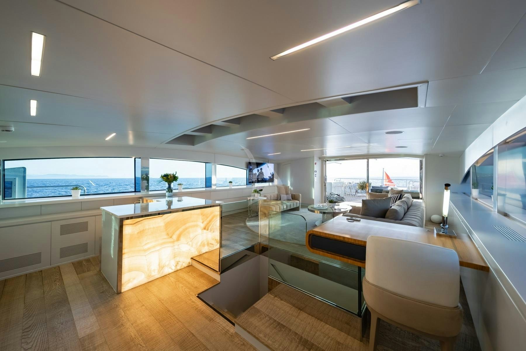 a room with a view of the ocean and the deck aboard SEA WOLF Yacht for Charter