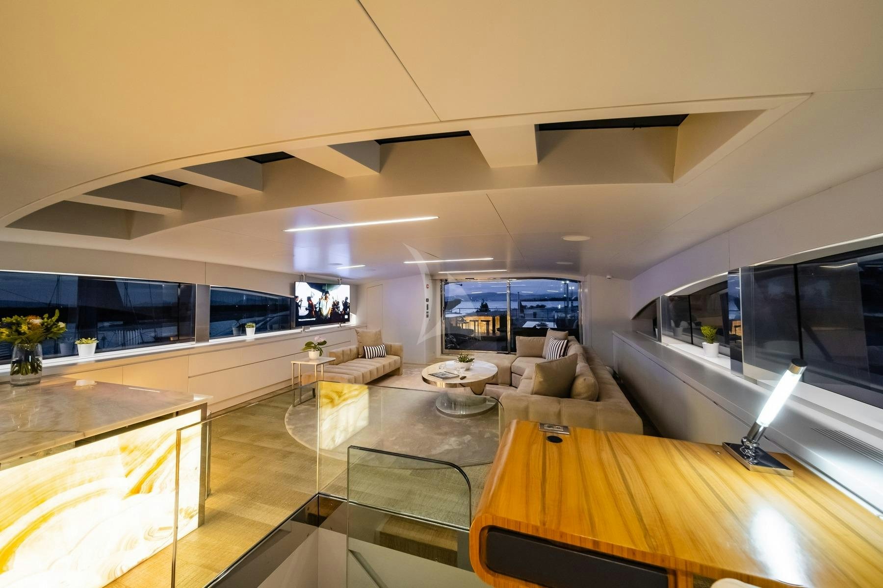 a room with a large tv and a table aboard SEA WOLF Yacht for Charter
