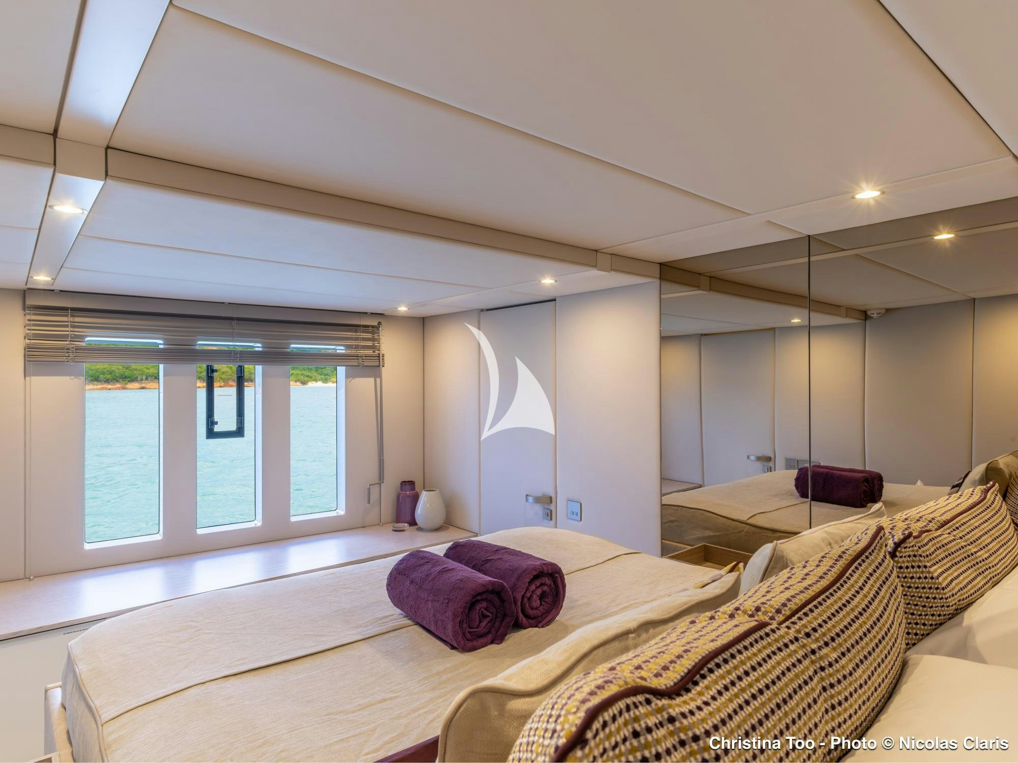 a bedroom with a bed and a large window aboard CHRISTINA TOO Yacht for Sale